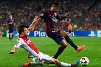 BARCELONA, SPAIN - OCTOBER 21:  Neymar of FC Barcelona competes for the ball with Joel Veltman of AFC Ajax during a UEFA Champions League Group F match between FC Barcelona and AFC Ajax at the Camp Nou Stadium on October 21, 2014 in Barcelona, Spain.  (Ph