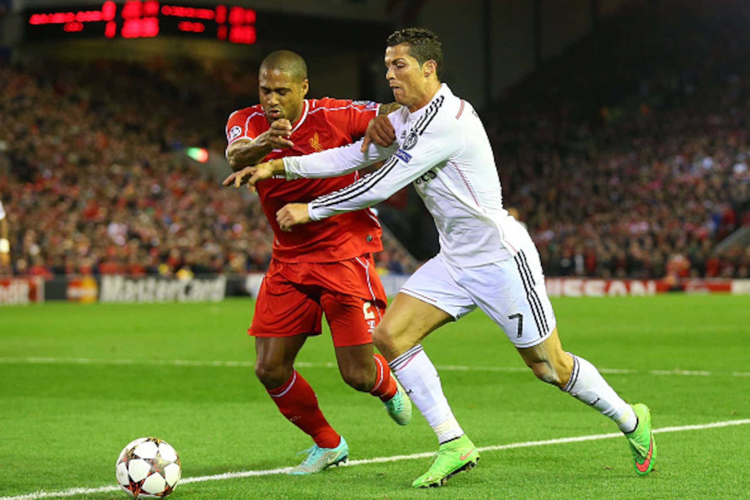LIVERPOOL, ENGLAND - OCTOBER 22:  Cristiano Ronaldo of Real Madrid competes with Glen Johnson of Liverpool  during the UEFA Champions League Group B match between Liverpool and Real Madrid CF on October 22, 2014 in Liverpool, United Kingdom.  (Photo by Al