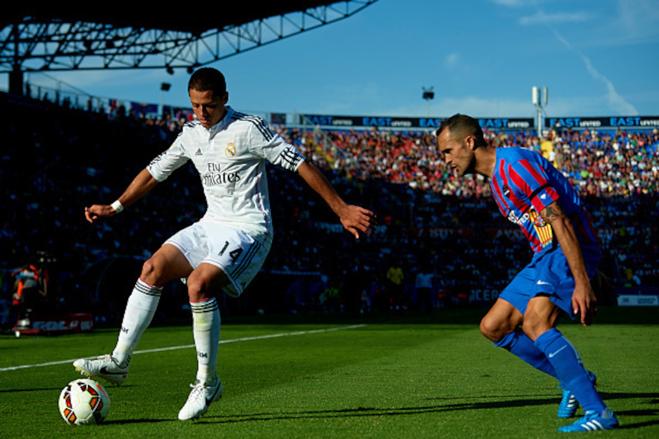 VALENCIA, SPAIN - OCTOBER 18:  Javier 'Chicharito' Hernandez (L) of Real Madrid controls the ball behind Juanfran of Levante during the La Liga match between Levante UD and Real Madrid at Ciutat de Valencia on October 18, 2014 in Valencia, Spain.  (Photo 