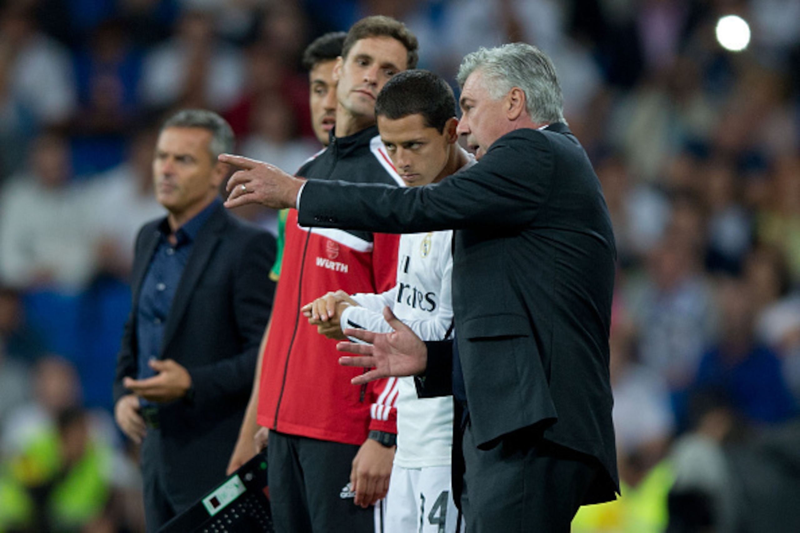 MADRID, SPAIN - SEPTEMBER 23: head coach Carlo Ancelotti (R) of Real Madrid CF gives instructions to his player Javier Hernandez Chicharito (L) during the La Liga match between Real Madrid CF and Elche CF at Estadio Santiago Bernabeu on September 23, 2014