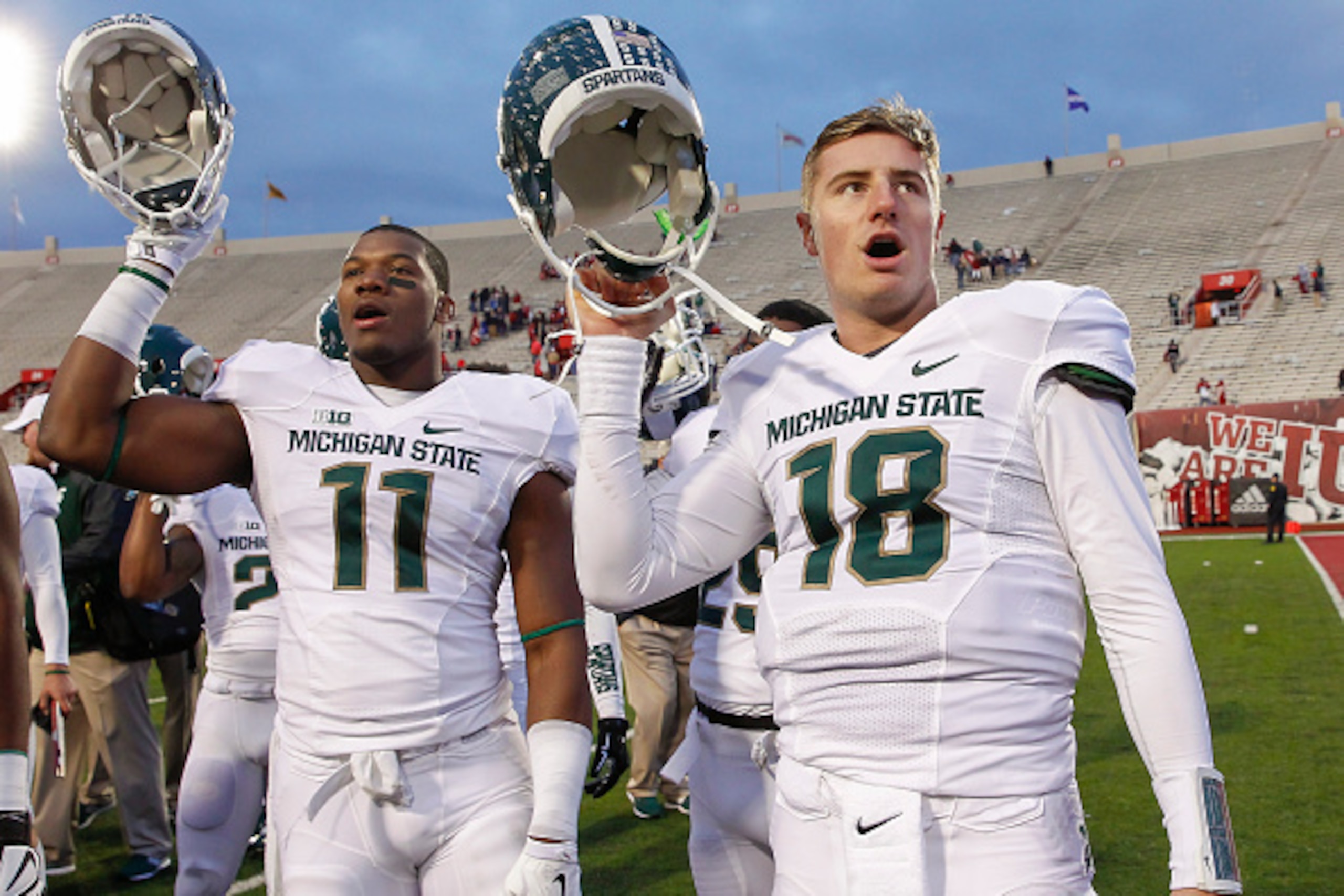 BLOOMINGTON, IN - OCTOBER 18: Jamal Lyles #11 Connor Cook #18 of the Michigan State Spartans celebrates after the game against the Indiana Hoosiers at Memorial Stadium on October 18, 2014 in Bloomington, Indiana. Michigan State defeated Indiana 56-17. (Ph