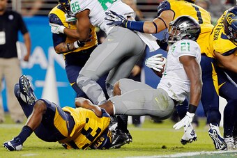 SANTA CLARA, CA - OCTOBER 24: Running back Royce Freeman #21 fo the Oregon Ducks falls backward into the endzone for a touchdown against cornerback Cedric Dozier #37 of the California Bears in the first quarter on October 24, 2014 at Levi's Stadium in San