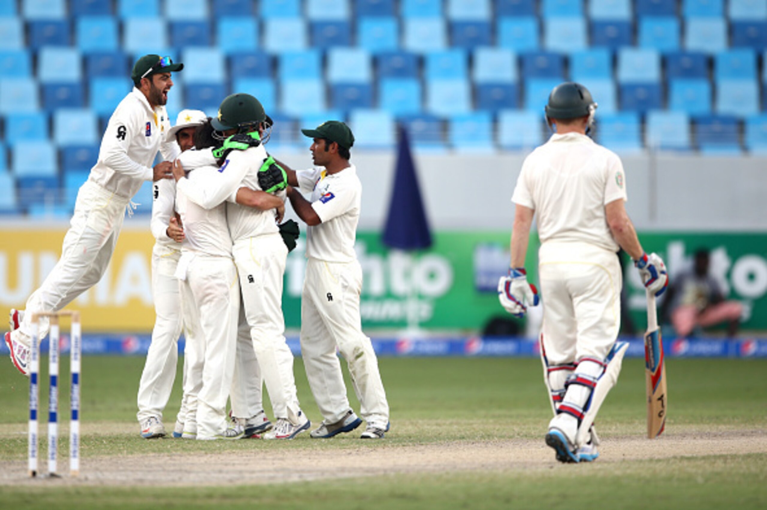DUBAI, UNITED ARAB EMIRATES - OCTOBER 25:  The Pakistan players celebrate as Australian Captain, Michael Clarke is dismissed lbw by Yasir Shah during day four of the First Test between Pakistan and Australia at Dubai International Stadium at Dubai Interna