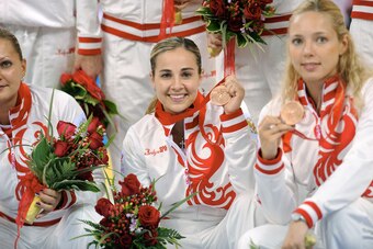 Becky Hammon poses with the bronze medal earned with her Russian teammates.