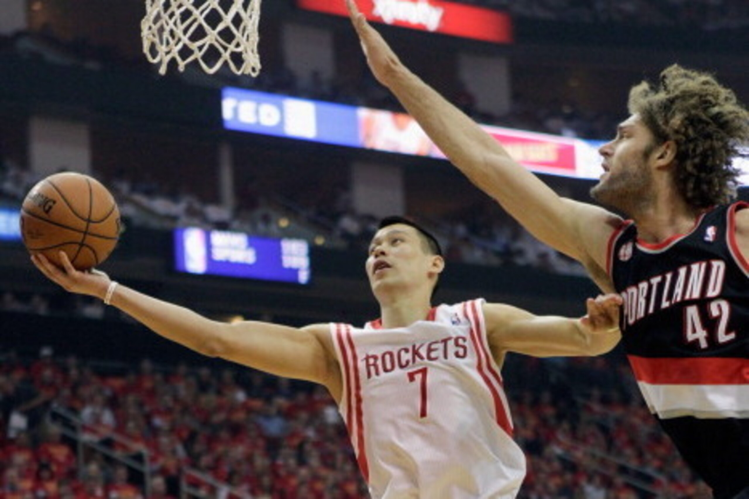 HOUSTON, TX - APRIL 30:  Jeremy Lin #7 of the Houston Rockets drives to the basket around Robin Lopez #42 of the Portland Trail Blazers and Damian Lillard #0 in Game 5 of the Western Conference Quarterfinals during the 2014 NBA Playoffs at the Toyota Cent