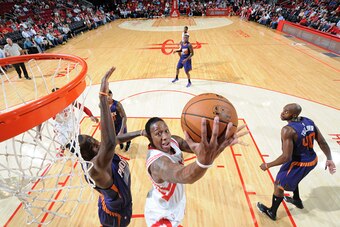 HOUSTON, TX - OCTOBER 13:  Isaiah Canaan #0 of of the Houston Rockets goes up for a shot against the Phoenix Suns on October 13, 2014 at the Toyota Center in Houston, Texas. NOTE TO USER: User expressly acknowledges and agrees that, by downloading and or