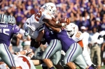 Oct 25, 2014; Manhattan, KS, USA; Texas Longhorns running back Johnathan Gray (32) tries to get a first down during a 23-0 loss to the Kansas State Wildcats at Bill Snyder Family Stadium. Mandatory Credit: Scott Sewell-USA TODAY Sports