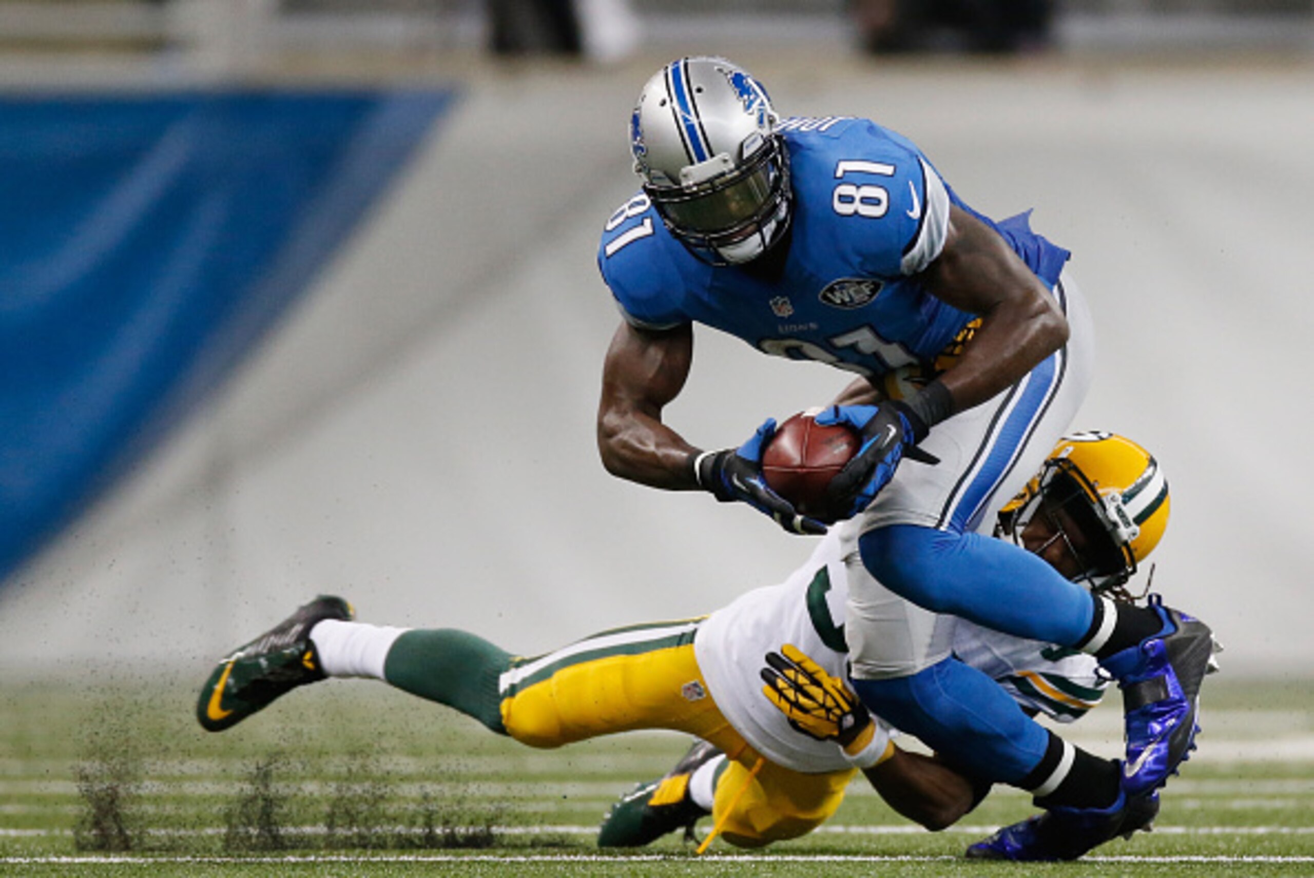 DETROIT, MI - SEPTEMBER 21: Calvin Johnson #81 of the Detroit Lions tries to avoid the tackle by Tramon Williams #38 of the Green Bay Packers in the fourth quarter at Ford Field on September 21, 2014 in Detroit, Michigan the lions win 19-7. (Photo by Greg