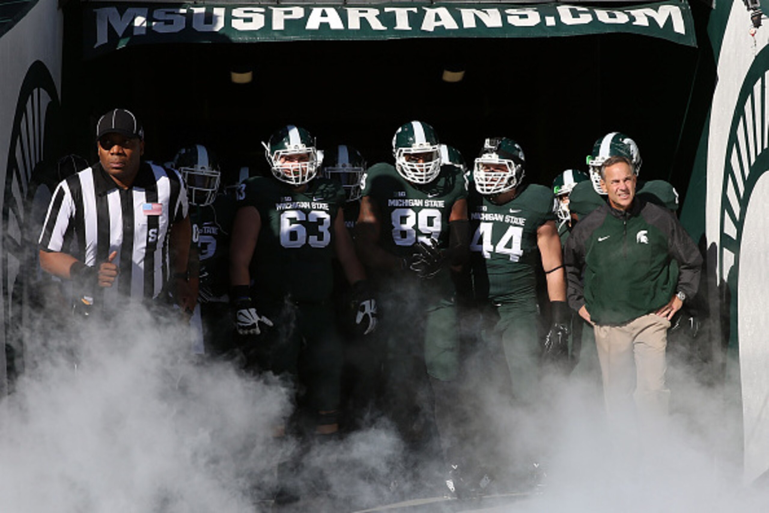 EAST LANSING, MI - OCTOBER 25: Head football coach Mark Dantonio leads his team onto the field prior to the start of the game against the Michigan Wolverines at Spartan Stadium on October 25 , 2014 in East Lansing, Michigan. (Photo by Leon Halip/Getty Ima