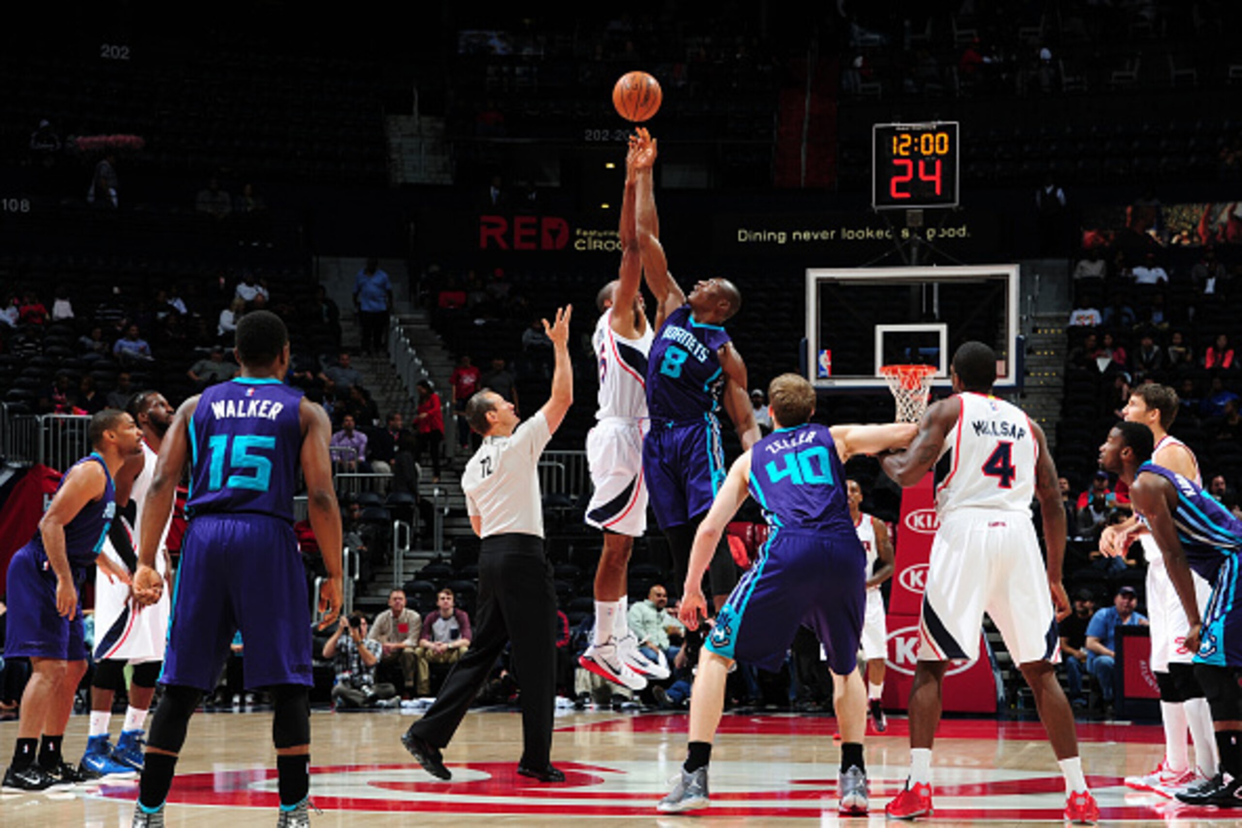 ATLANTA, GA - OCTOBER 20: Bismack Biyombo #8 of the Charlotte Hornets tips off against the Atlanta Hawks on October 20, 2014 at Philips Arena in Atlanta, Georgia.  NOTE TO USER: User expressly acknowledges and agrees that, by downloading and/or using this