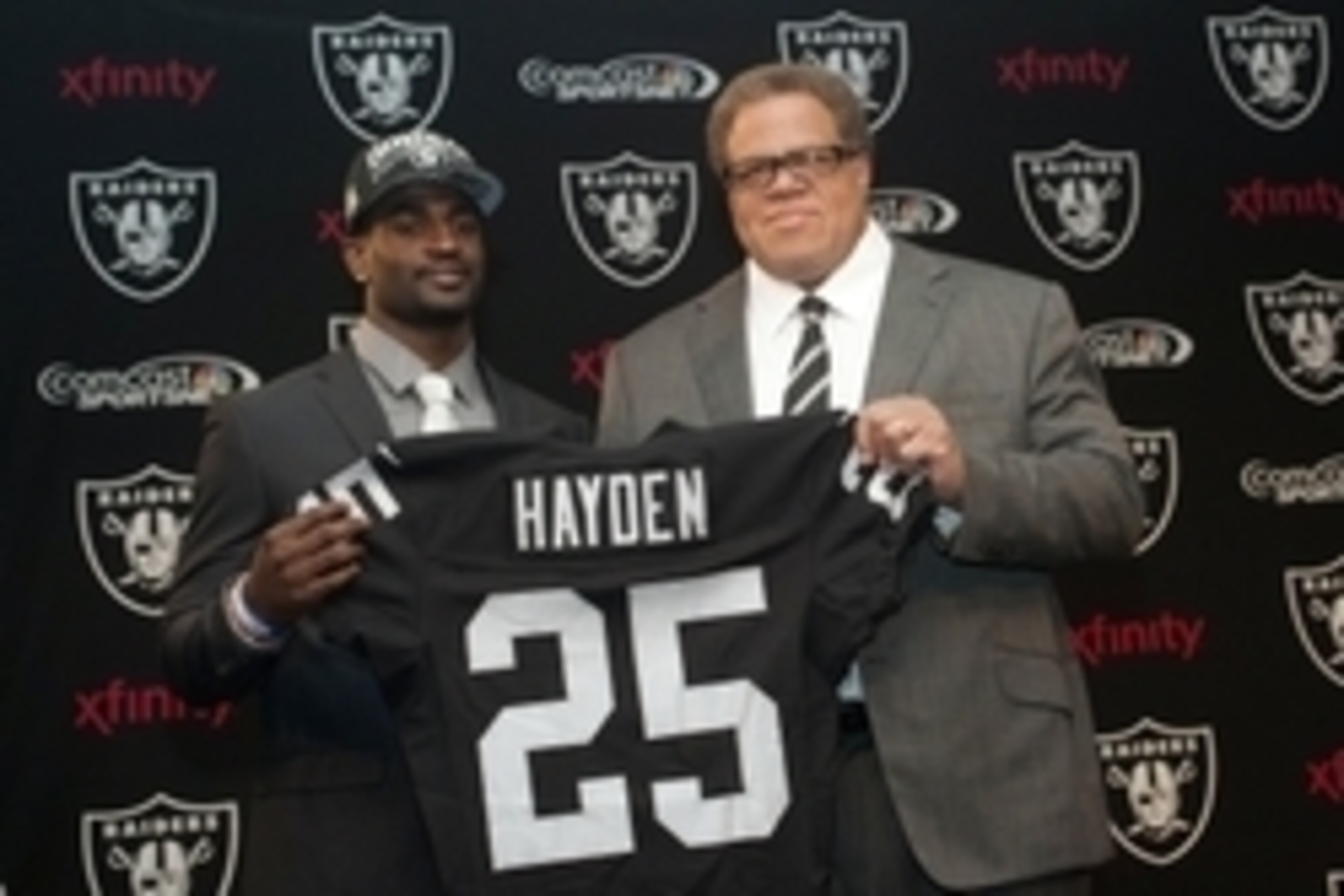 Apr 26, 2013; Alameda, CA, USA; Oakland Raiders first round selection D.J. Hayden and general manager Reggie McKenzie hold up a jersey at the press conference at Oakland Raiders headquarters. Mandatory Credit: Ed Szczepanski-USA TODAY Sports