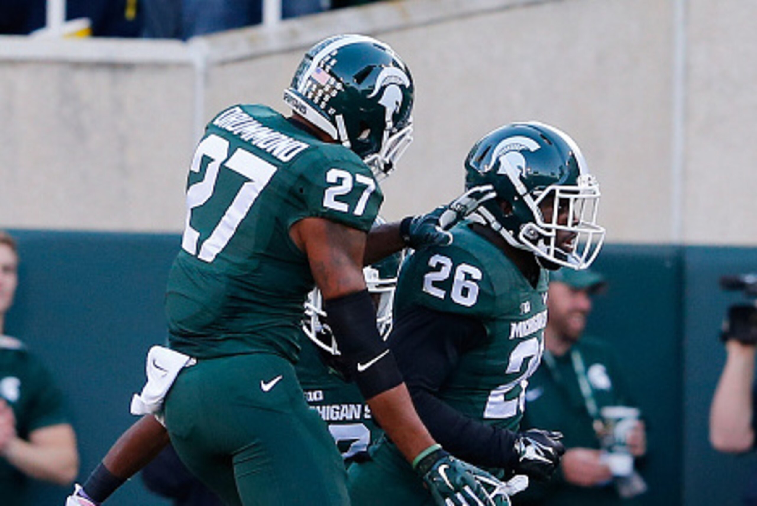 EAST LANSING, MI - OCTOBER 25: RJ Williamson #26 of the Michigan State Spartans celebrates after intercepting a pass from Devin Gardner (not in photo) of the Michigan Wolverines  and running 29 yards for the touchdown during the third quarter of the game 
