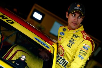 MARTINSVILLE, VA - OCTOBER 24:  Joey Logano, driver of the #22 Shell Pennzoil Ford, climbs into his car prior to qualifying for the NASCAR Sprint Cup Series Goody's Headache Relief Shot 500 at Martinsville Speedway on October 24, 2014 in Martinsville, Vir