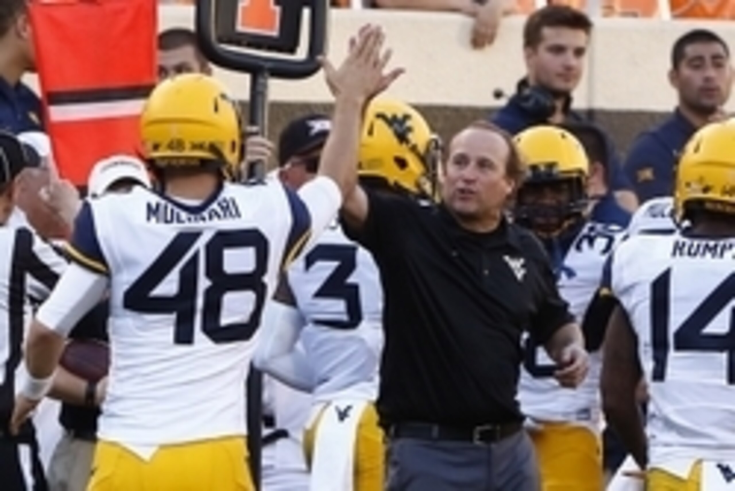 Oct 25, 2014; Stillwater, OK, USA; West Virginia Mountaineers head coach Dana Holgorsen celebrates with place kicker Michael Molinari (48) during the fourth quarter at Boone Pickens Stadium. West Virginia won 34-10. Mandatory Credit: Alonzo Adams-USA TODA