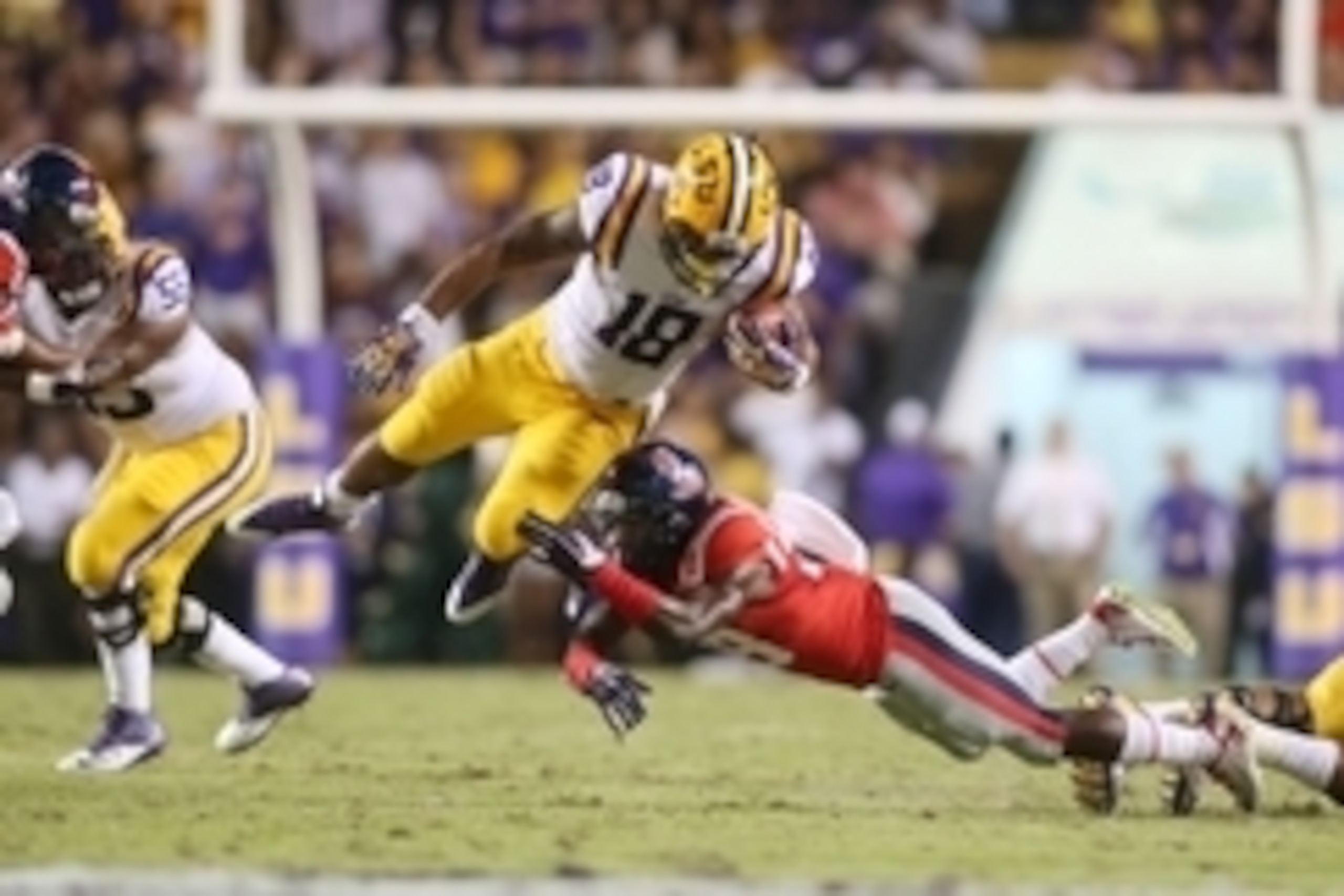 Oct 25, 2014; Baton Rouge, LA, USA; Mississippi Rebels defensive back Mike Hilton (28) reaches for LSU Tigers running back Terrence Magee (18) as he carries the ball in the first half at Tiger Stadium. Mandatory Credit: Crystal LoGiudice-USA TODAY Sports