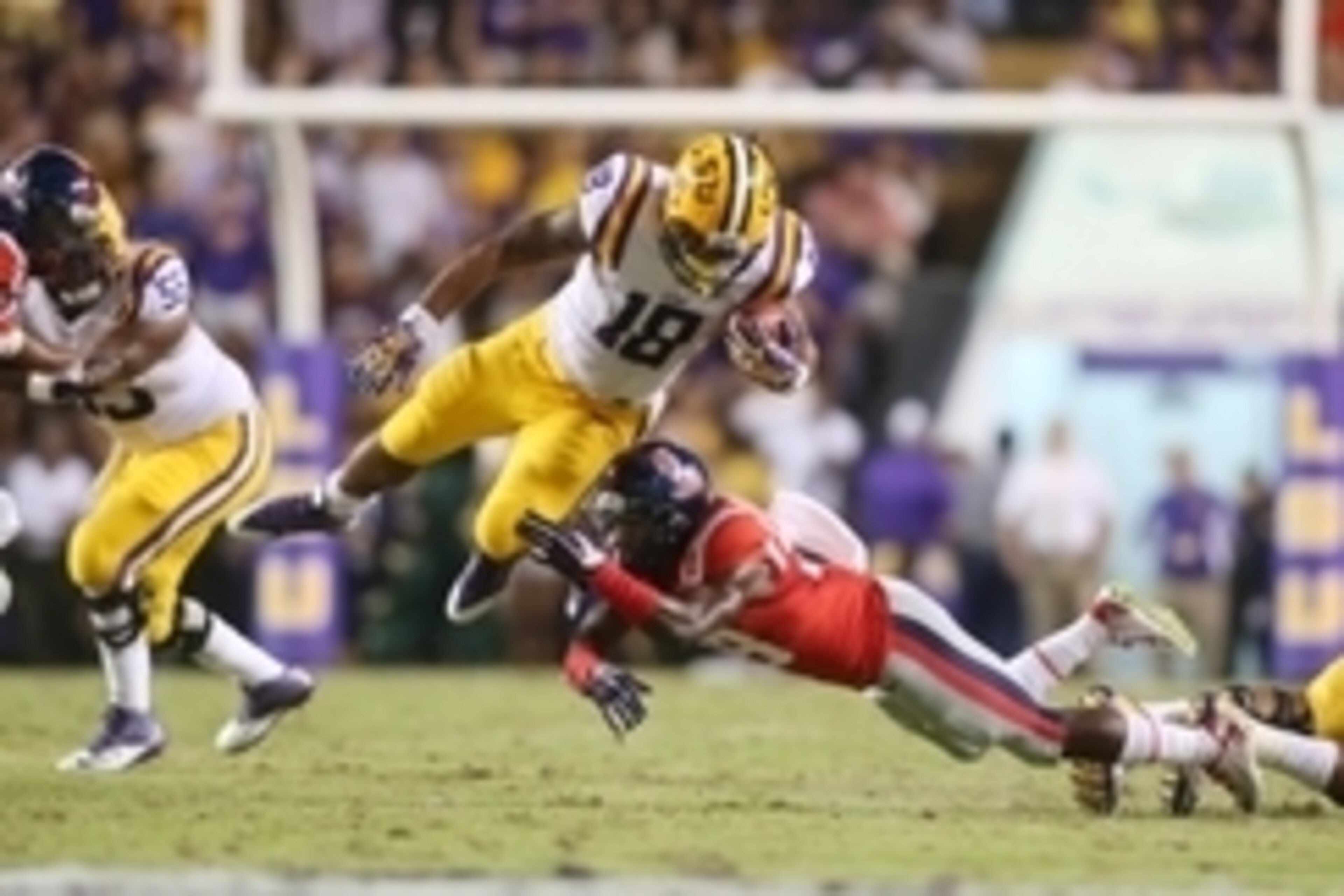 Oct 25, 2014; Baton Rouge, LA, USA; Mississippi Rebels defensive back Mike Hilton (28) reaches for LSU Tigers running back Terrence Magee (18) as he carries the ball in the first half at Tiger Stadium. Mandatory Credit: Crystal LoGiudice-USA TODAY Sports
