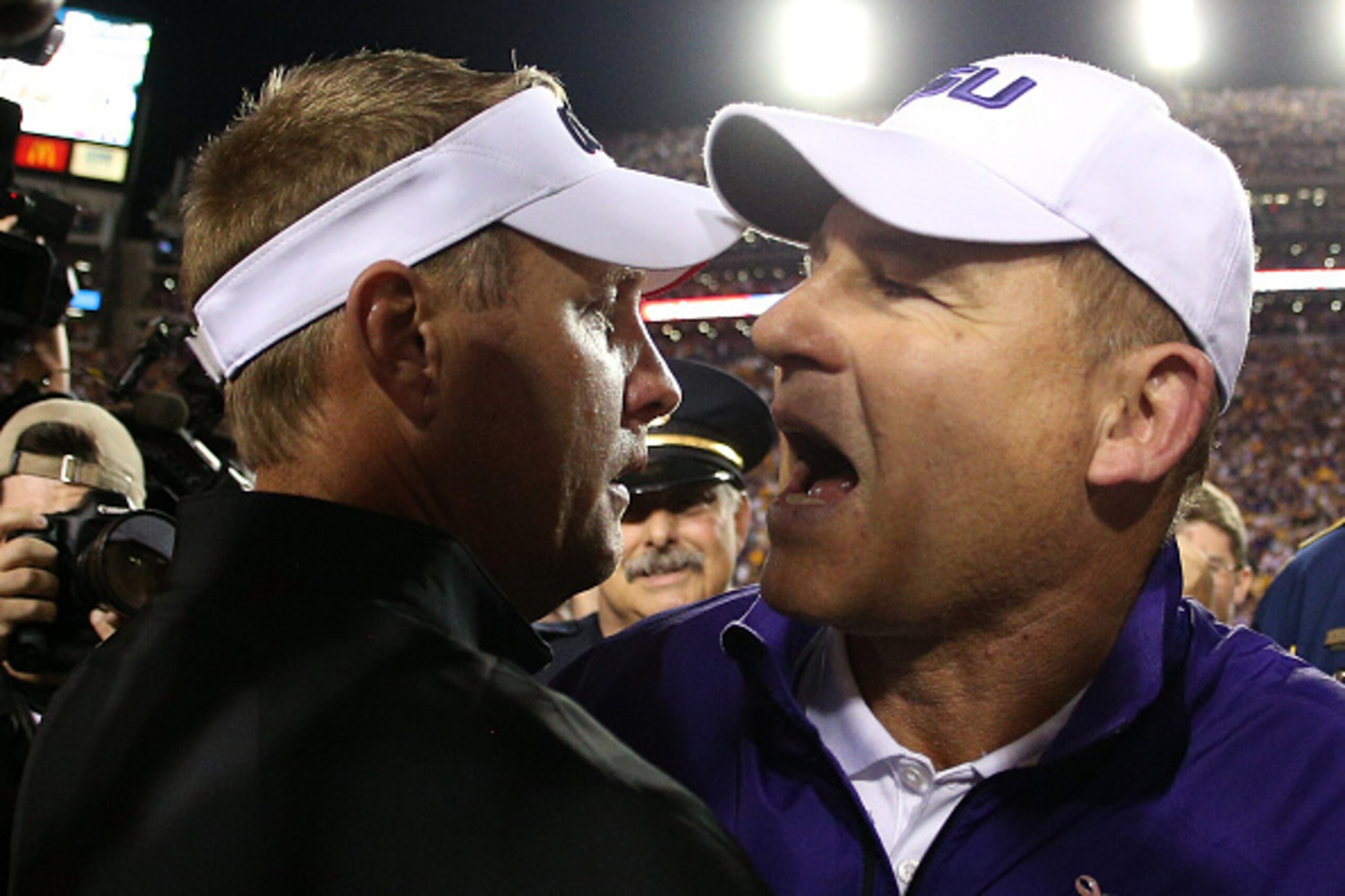 BATON ROUGE, LA - OCTOBER 25:  Head coach Hugh Freeze of the Mississippi Rebels talks with head coach Les Miles of the LSU Tigers at Tiger Stadium on October 25, 2014 in Baton Rouge, Louisiana. The Tigers defeated the Rebels 10-7.  (Photo by Chris Graythe