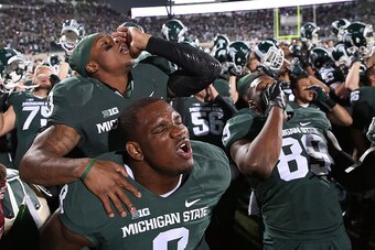 EAST LANSING, MI - OCTOBER 25: Mike Sadler #3 and Lawrence Thomas #8 of the Michigan State Spartans celebrates a win over the Michigan Wolverines at Spartan Stadium on October 25 , 2014 in East Lansing, Michigan. The Spartans defeated the Wolverines 35-11
