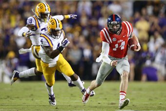 BATON ROUGE, LA - OCTOBER 25:  Bo Wallace #14 of the Mississippi Rebels is chased by Kwon Alexander #4 of the LSU Tigers at Tiger Stadium on October 25, 2014 in Baton Rouge, Louisiana.  (Photo by Chris Graythen/Getty Images)
