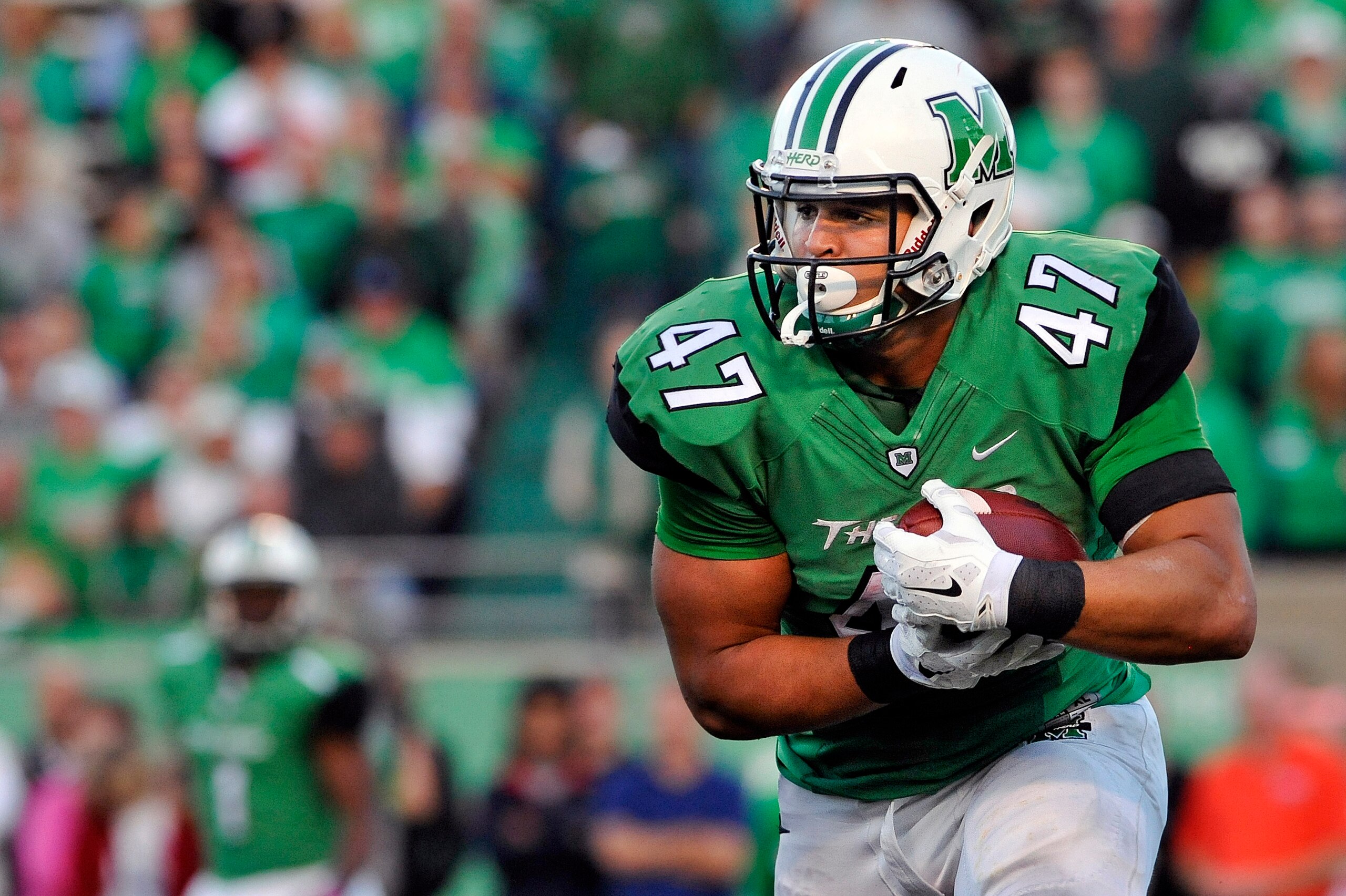 Oct 25, 2014; Huntington, WV, USA; Marshall Thundering Herd running back Devon Johnson (47) rushes the ball in the fourth quarter against the Florida Atlantic Owls at Joan C. Edwards Stadium. Marshall defeated Florida Atlantic 35-16 and Johnson finished w
