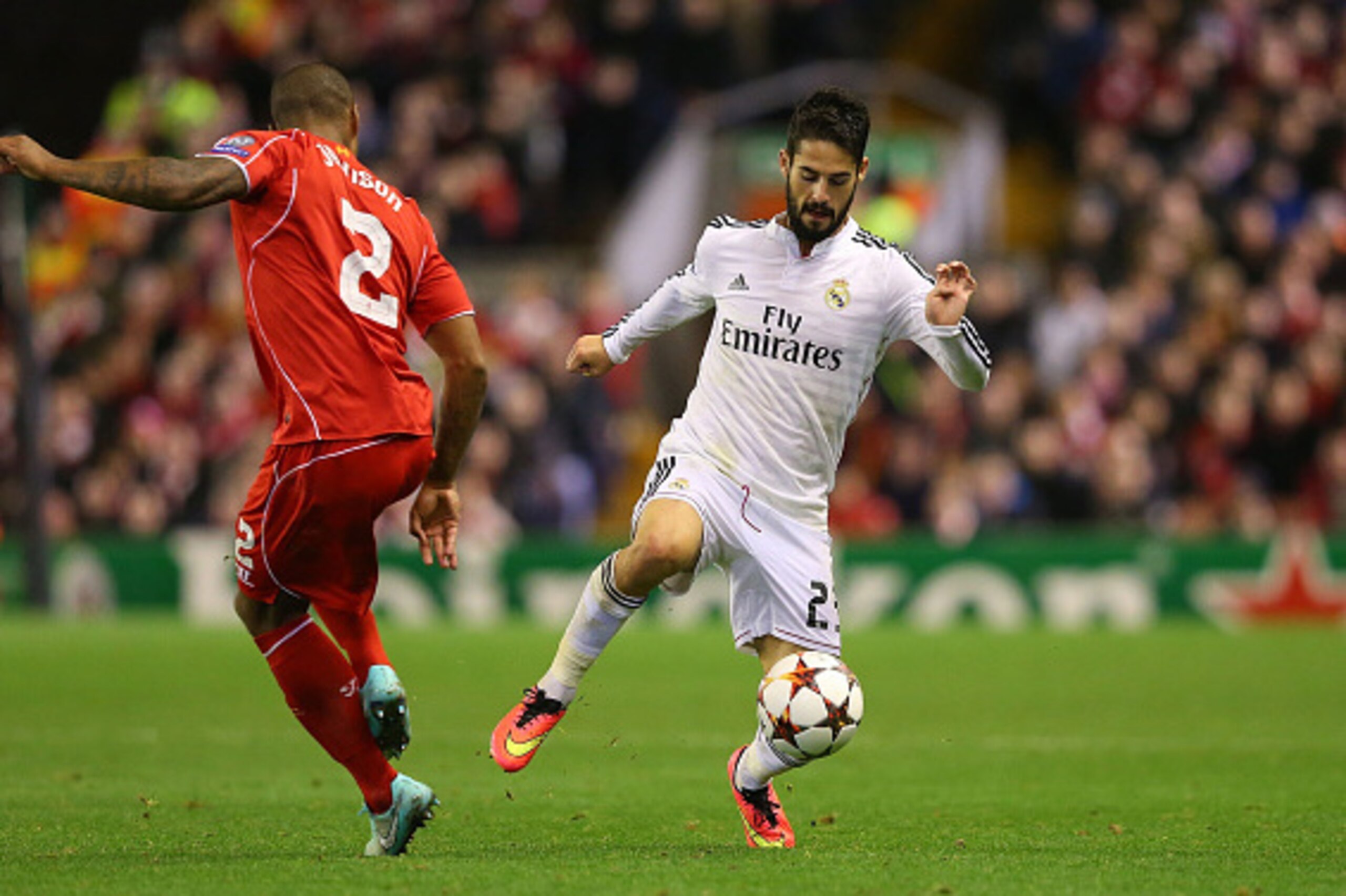 LIVERPOOL, ENGLAND - OCTOBER 22:  Isco of Real Madrid competes with Glen Johnson of Liverpool during the UEFA Champions League Group B match between Liverpool and Real Madrid CF on October 22, 2014 in Liverpool, United Kingdom.  (Photo by Alex Livesey/Get