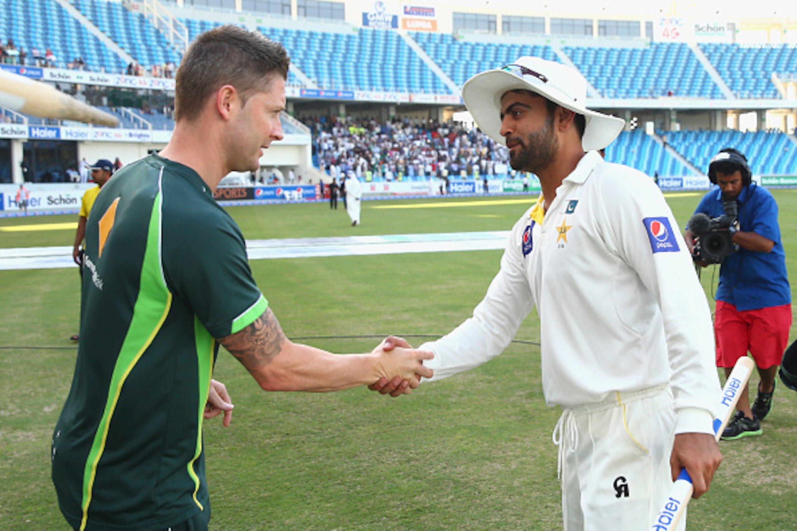 DUBAI, UNITED ARAB EMIRATES - OCTOBER 26:  Michael Clarke of Australia congratulates Ahmed Shehzad of Pakistan after Pakistan claimed victory during Day Five of the First Test between Pakistan and Australia at Dubai International Stadium on October 26, 20