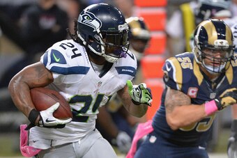 ST. LOUIS, MO - OCTOBER 19: Marshawn Lynch #24 of the Seattle Seahawks rushes against the St. Louis Rams in the third quarter at the Edward Jones Dome on October 19,  2014 in St. Louis, Missouri. The Rams defeated the Seahawks 28-26.  (Photo by Michael B.