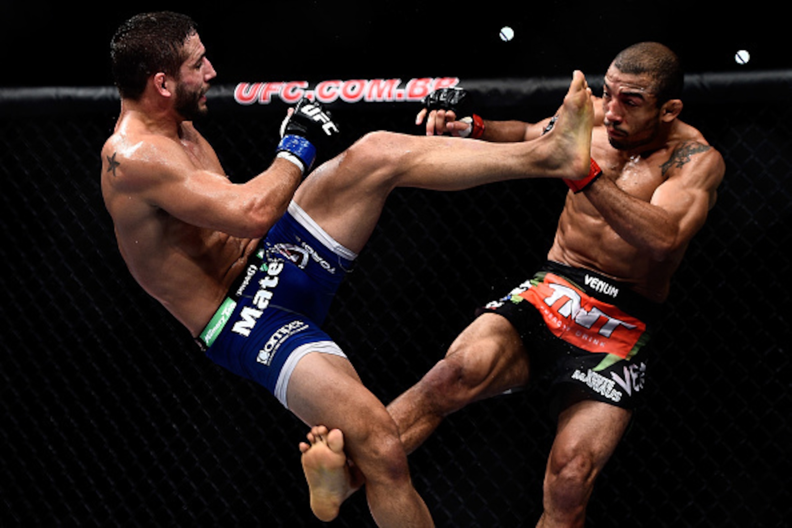 RIO DE JANEIRO, BRAZIL - OCTOBER 25: Chad Mendes of the United States kicks Jose Aldo of Brazil in their featherweight championship bout during the UFC 179 event at Maracanazinho on October 25, 2014 in Rio de Janeiro, Brazil. (Photo by Buda Mendes/Getty I