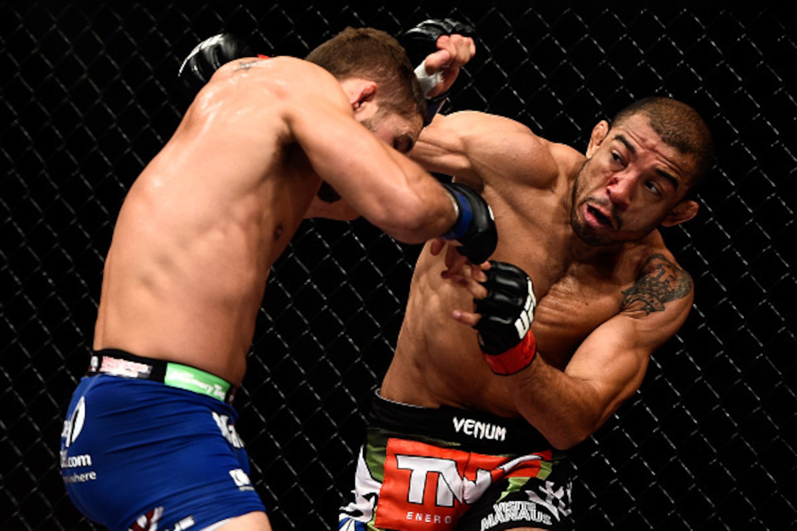 RIO DE JANEIRO, BRAZIL - OCTOBER 25: Jose Aldo of Brazil punches Chad Mendes of the United States in their featherweight championship bout during the UFC 179 event at Maracanazinho on October 25, 2014 in Rio de Janeiro, Brazil. (Photo by Buda Mendes/Getty
