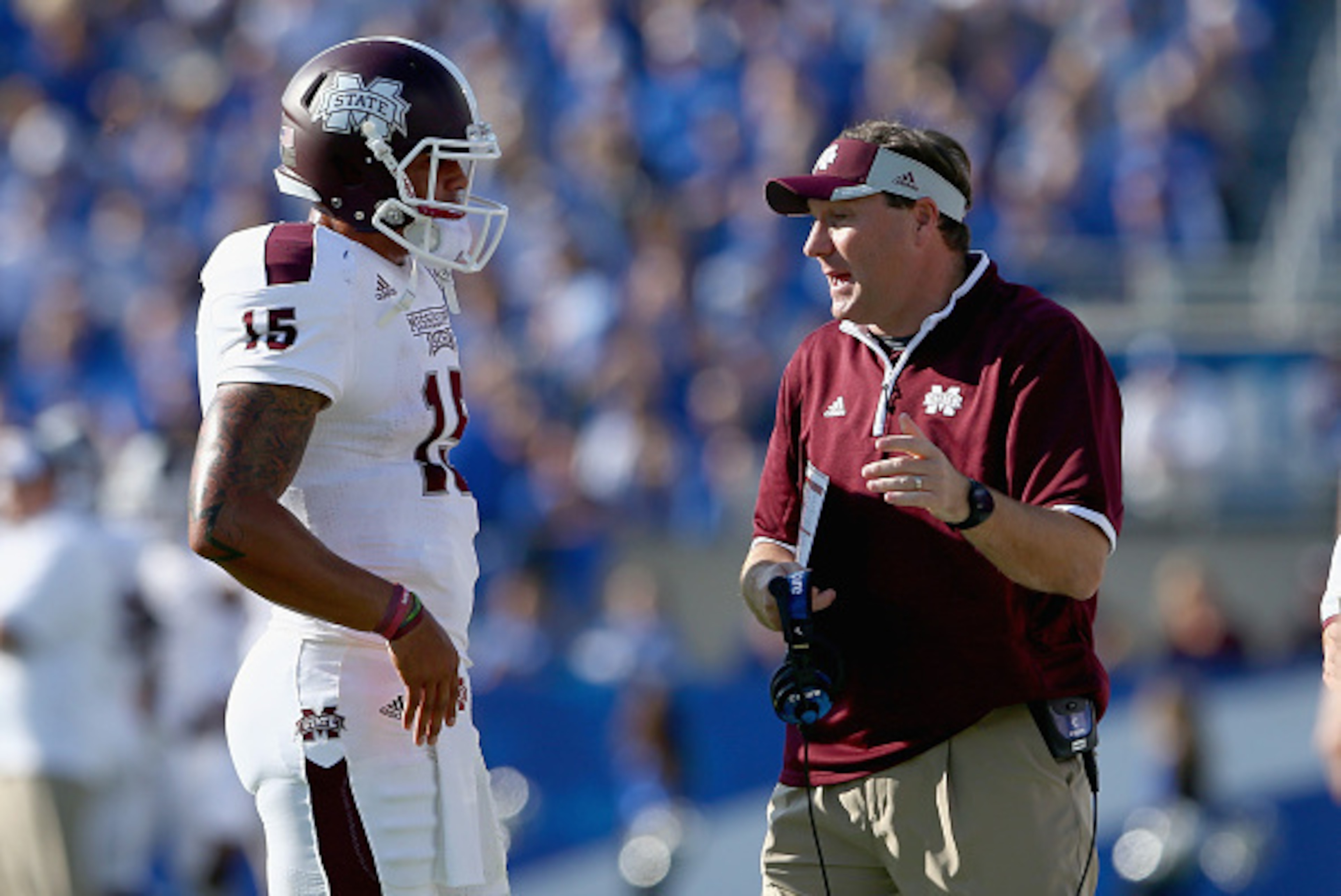 LEXINGTON, KY - OCTOBER 25:  Dak Prescott #15 of the Mississippi State Bulldogs runs talks with head coach Dan Mullens during the game against the Kentucky Wildcats at Commonwealth Stadium on October 25, 2014 in Lexington, Kentucky.  (Photo by Andy Lyons/