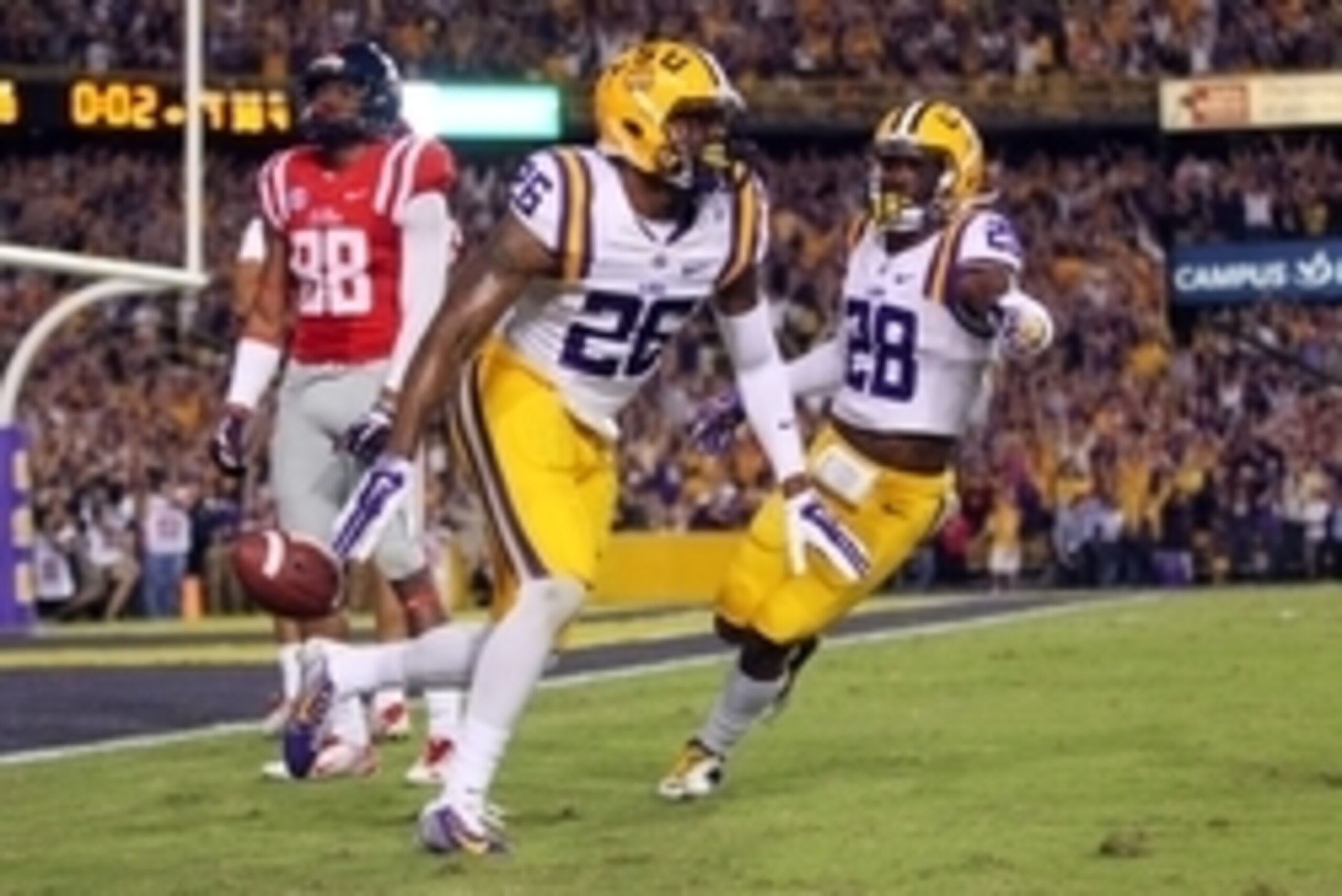 Oct 25, 2014; Baton Rouge, LA, USA; LSU Tigers safety Ronald Martin (26) is congratulated by safety Jalen Mills (28) after Martin intercept the ball in front of Mississippi Rebels wide receiver Cody Core (88) with seconds left in the fourth quarter at Tig