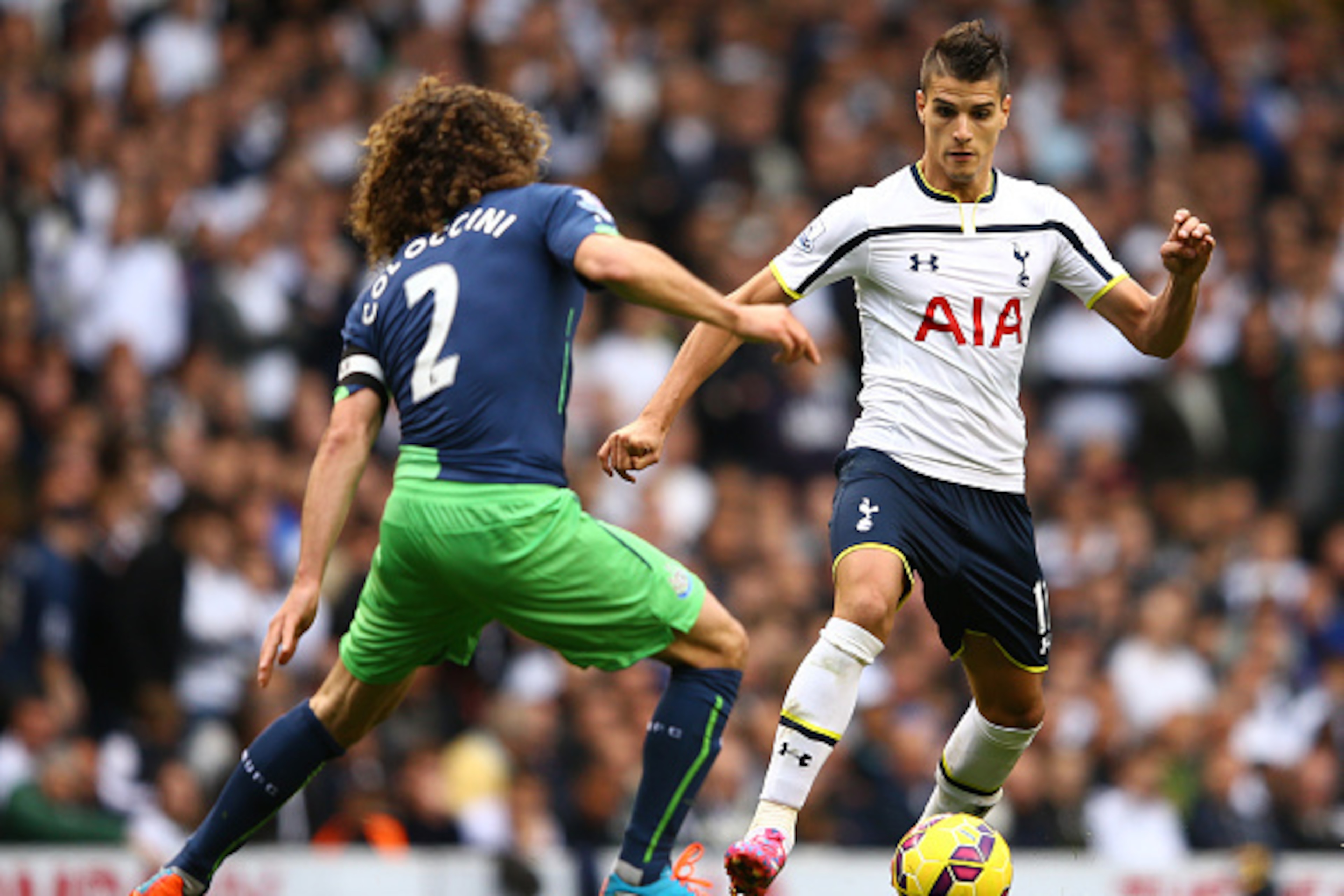 LONDON, ENGLAND - OCTOBER 26:  Erik Lamela of Spurs battles for the ball with Fabricio Coloccini of Newcastle United during the Barclays Premier League match between Tottenham Hotspur and Newcastle United at White Hart Lane on October 26, 2014 in London, 