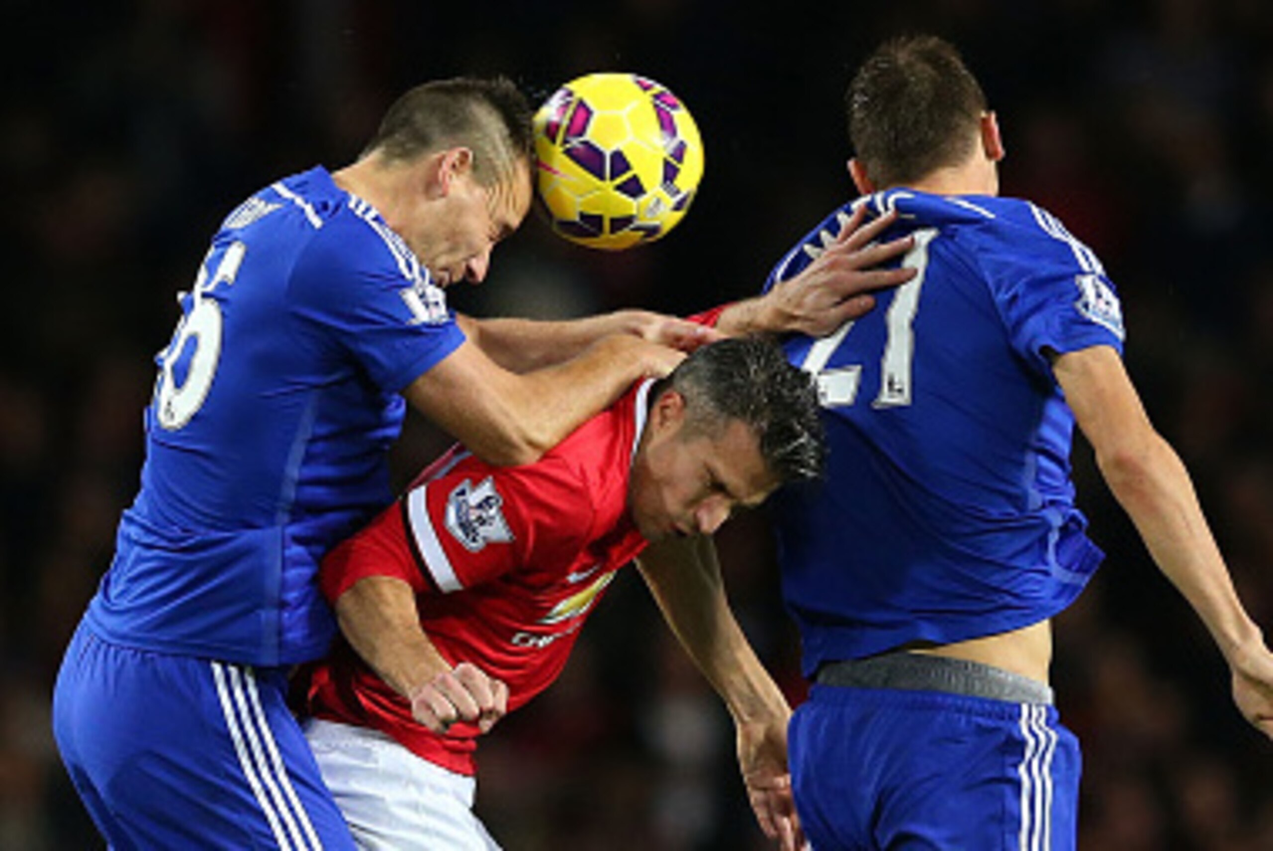 MANCHESTER, ENGLAND - OCTOBER 26:  Robin van Persie of Manchester United competes in the air with John Terry and Nemanja Matic (R) of Chelsea during the Barclays Premier League match between Manchester United and Chelsea at Old Trafford on October 26, 201