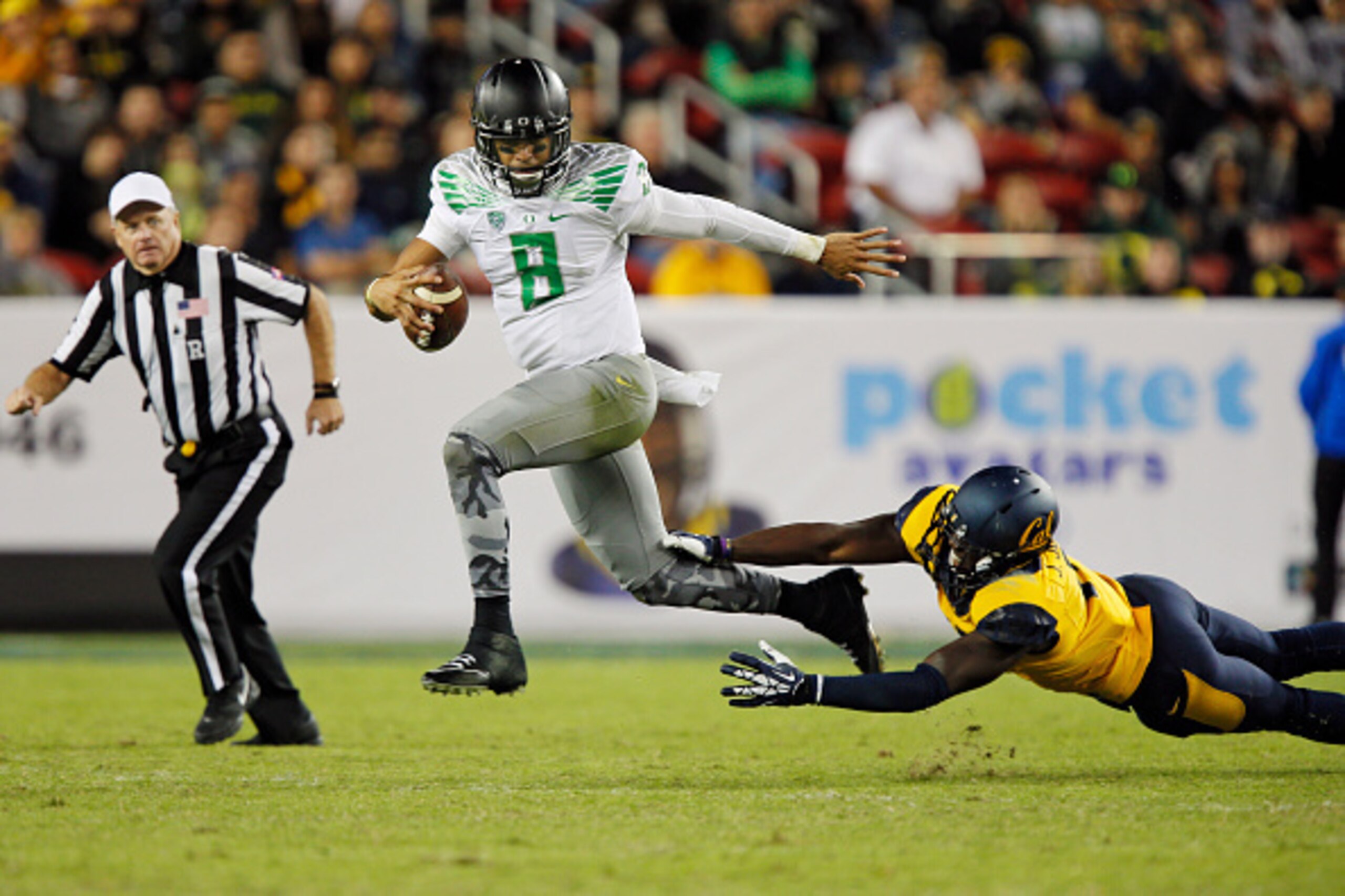 SANTA CLARA, CA - OCTOBER 24:  Quarterback Marcus Mariota #8 of the Oregon Ducks steps out of the grasp of defensive end Jonathan Johnson #11 of the California Golden Bears in the third quarter on October 24, 2014 at Levi's Stadium in Santa Clara, Califor