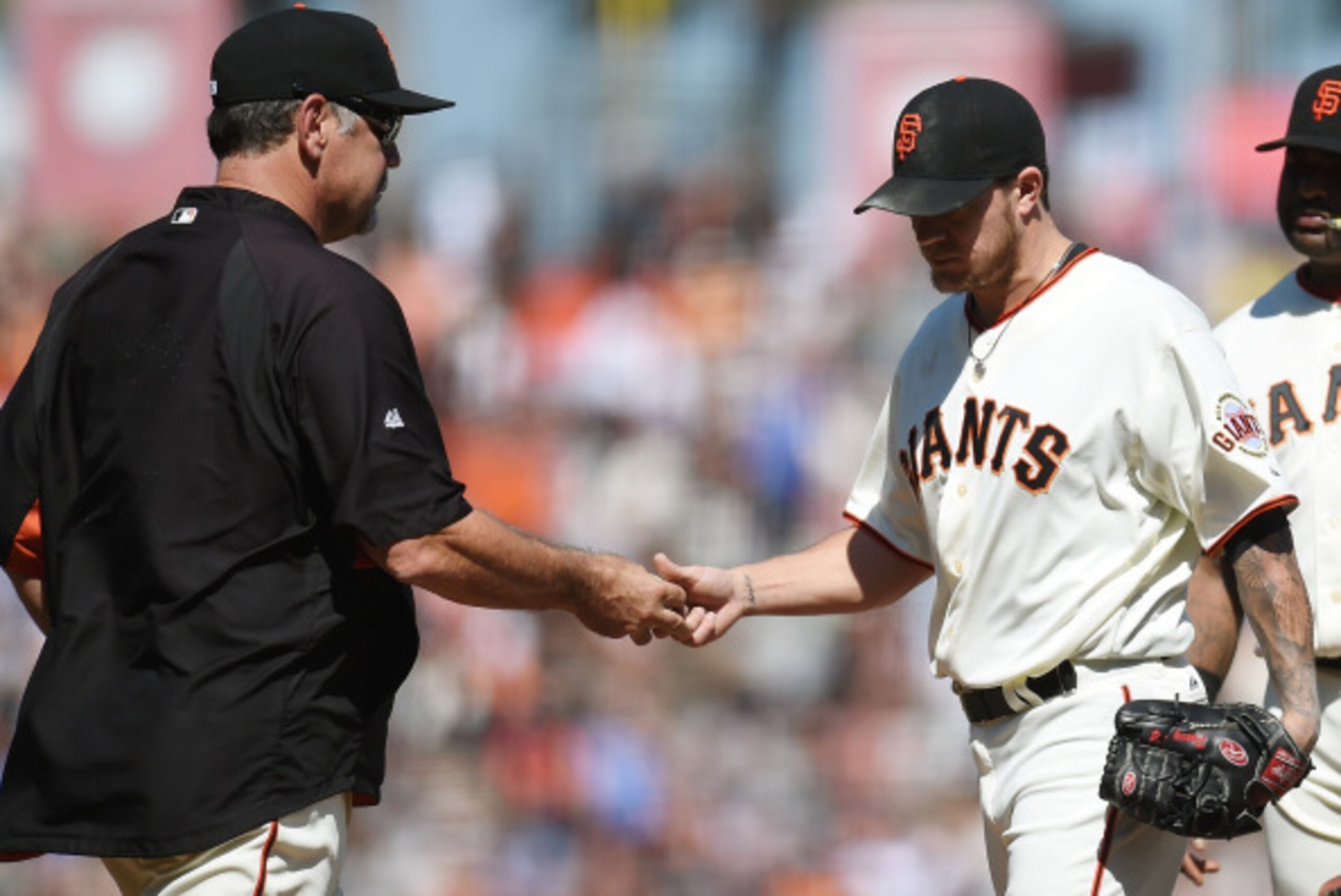 SAN FRANCISCO, CA - SEPTEMBER 11:  Manager Bruce Bochy #15 of the San Francisco Giants take the ball from starting pitcher Jake Peavy #22 taking Peavy out of the game against the Arizona Diamondbacks in the top of the six inning at AT&T Park on September 