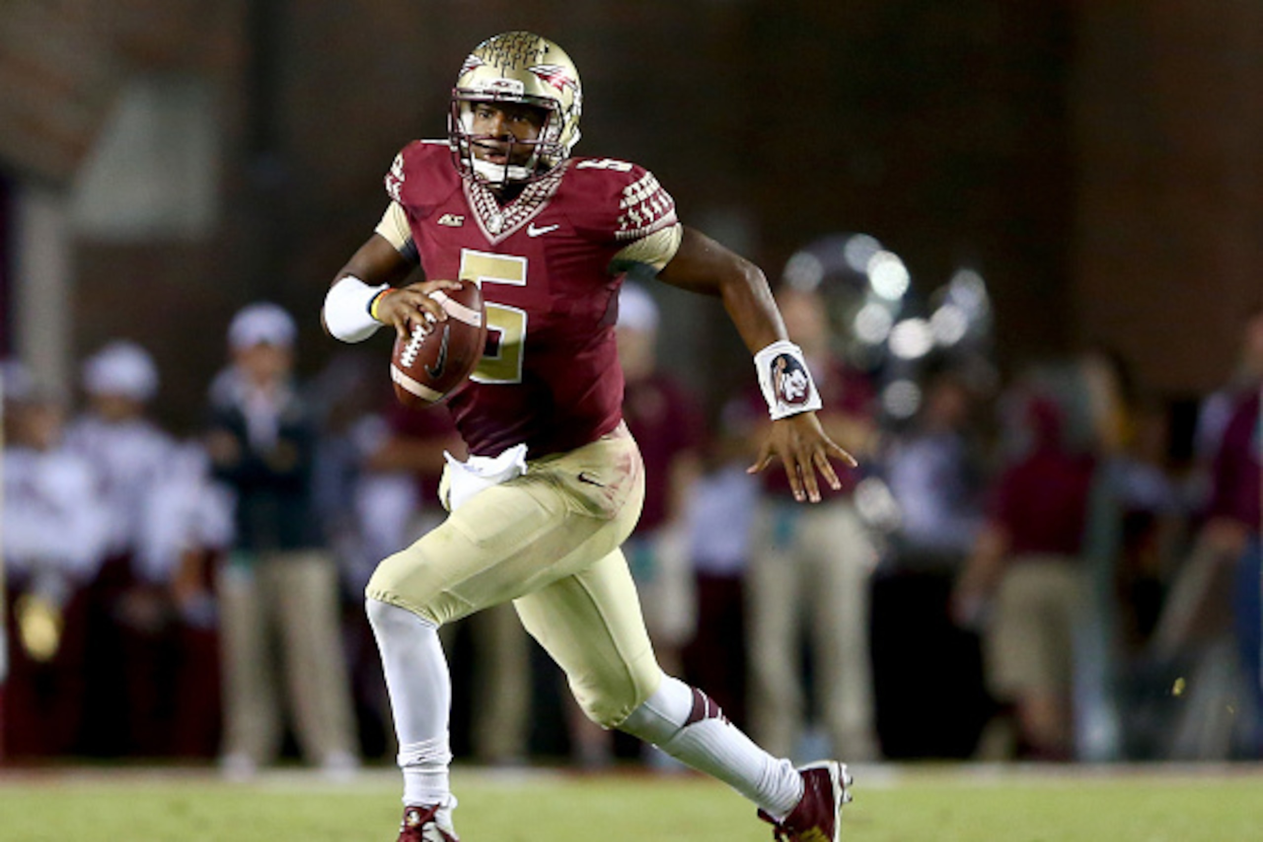 TALLAHASSEE, FL - OCTOBER 18:  Jameis Winston #5 of the Florida State Seminoles runs with the ball against the Notre Dame Fighting Irish during their game at Doak Campbell Stadium on October 18, 2014 in Tallahassee, Florida.  (Photo by Streeter Lecka/Gett