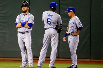 SAN FRANCISCO, CA - OCTOBER 26: Alex Gordon #4, Lorenzo Cain #6, and Norichika Aoki #23 of the Kansas City Royals stand in the outfield during a pitching change in the eighth inning against the San Francisco Giants during Game Five of the 2014 World Serie