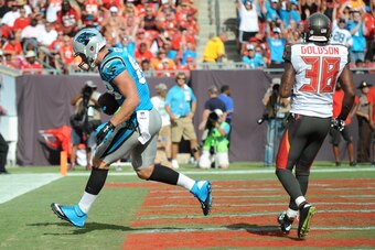TAMPA, FL - SEPTEMBER 7:  Tight end Greg Olsen #88 of the Carolina Panthers scores a touchdown against free safety Dashon Goldson #38 of the Tampa Bay Buccaneers during the second quarter at Raymond James Stadium on September 7, 2014 in Tampa, Florida. (P
