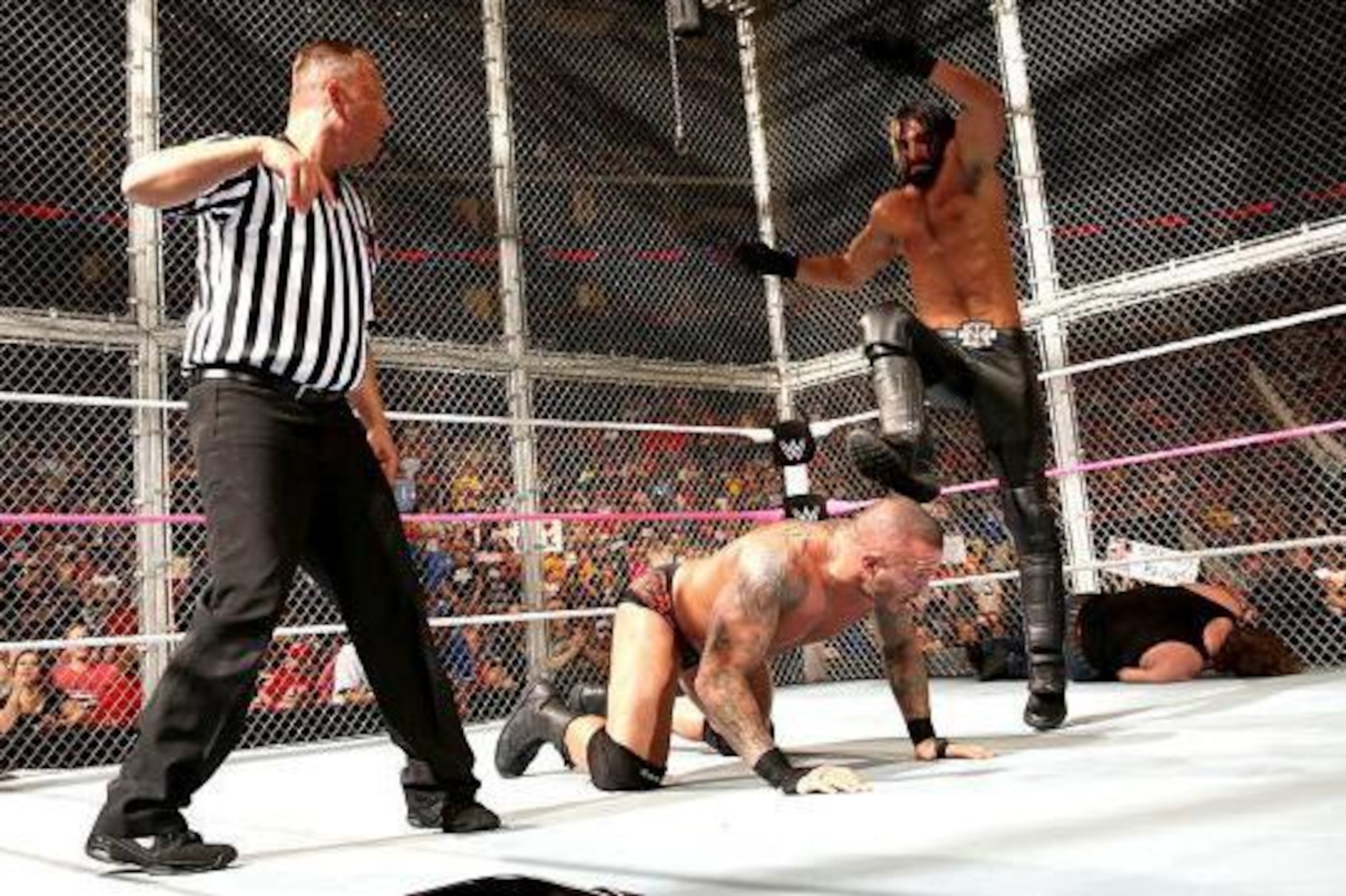 Seth Rollins attacks Randy Orton.