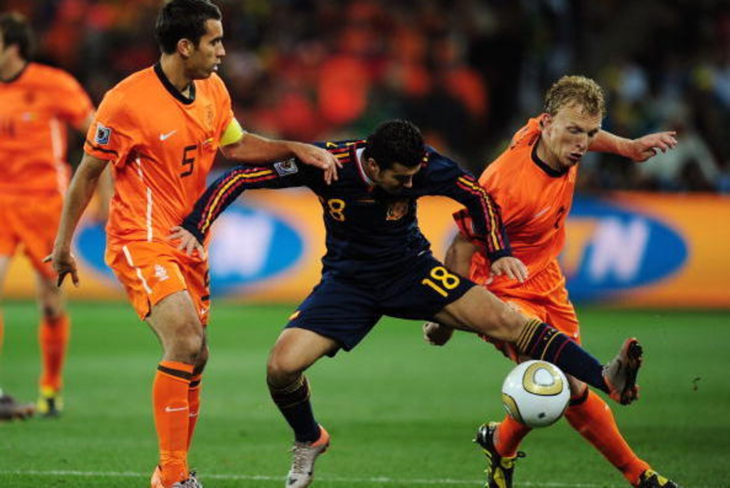 JOHANNESBURG, SOUTH AFRICA - JULY 11:  Giovanni Van Bronckhorst and Dirk Kuyt of the Netherlands challenge Pedro Rodriguez of Spain during the 2010 FIFA World Cup South Africa Final match between Netherlands and Spain at Soccer City Stadium on July 11, 20