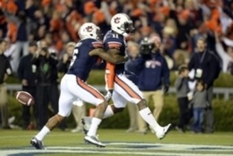 Nov 30, 2013; Auburn, AL, USA; Auburn Tigers cornerback Chris Davis (center) celebrates scoring a 100 yard touchdown on a missed field goal attempt with defensive back Jonathon Mincy (6) during the fourth quarter against the Alabama Crimson Tide at Jordan