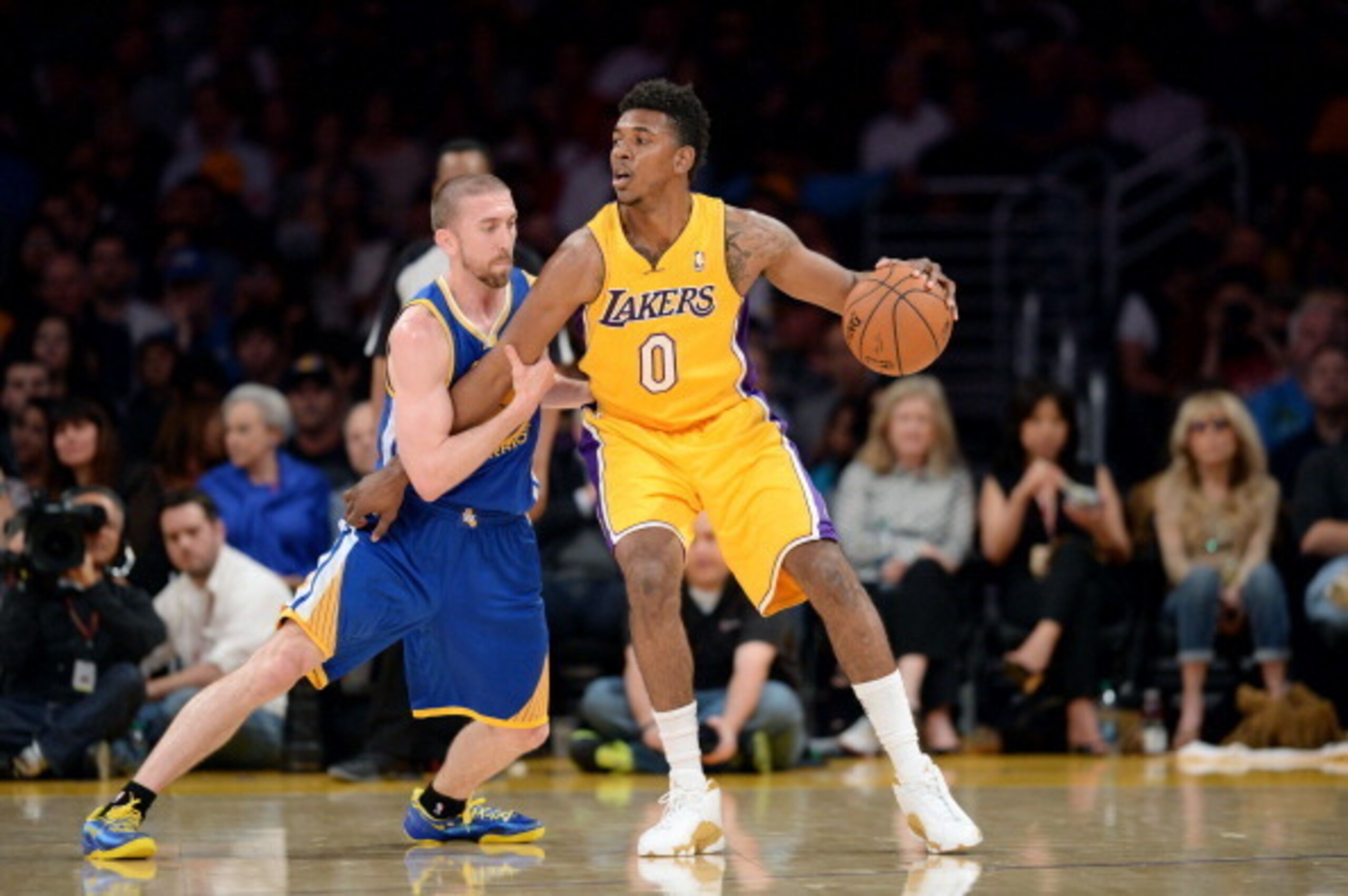 LOS ANGELES, CA - APRIL 11: Nick Young #0 of the Los Angeles Lakers handles the ball against Steve Blake #25 of the Golden State Warriors at Staples Center on April 11, 2014 in Los Angeles, California. NOTE TO USER: User expressly acknowledges and agrees LOS ANGELES, CA - APRIL 11: Nick Young #0 of the Los Angeles Lakers handles the ball against Steve Blake #25 of the Golden State Warriors at Staples Center on April 11, 2014 in Los Angeles, California. NOTE TO USER: User expressly acknowledges and agrees
