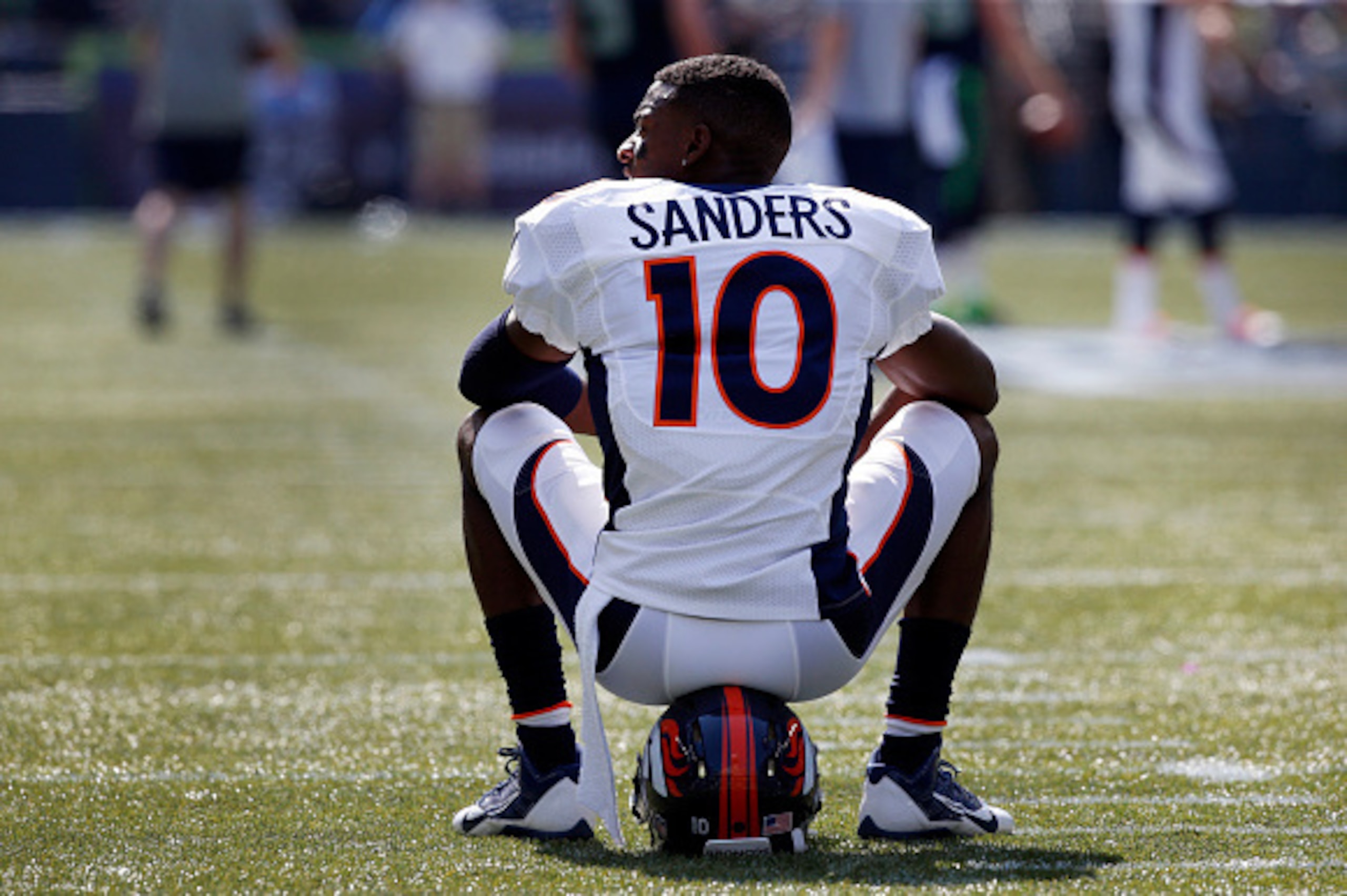 SEATTLE, WA - SEPTEMBER 21: Wide receiver Emmanuel Sanders #10 of the Denver Broncos sits on his helmet before the game against the Seattle Seahawks at CenturyLink Field on September 21, 2014 in Seattle,Washington. (Photo by Otto Greule Jr/Getty Images)
