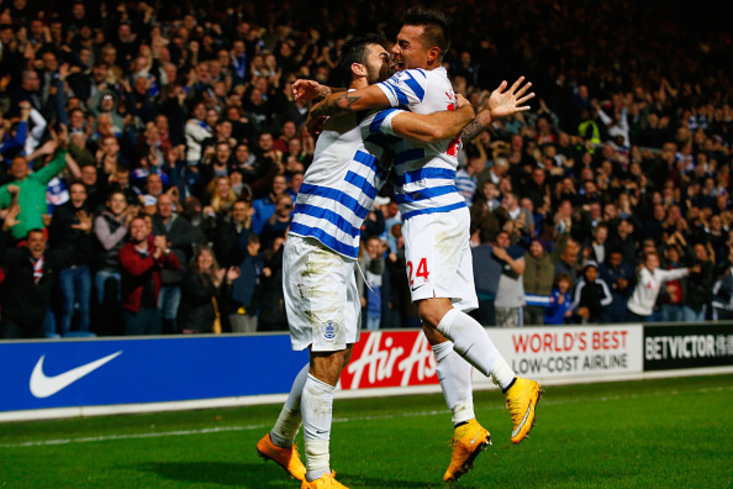 LONDON, ENGLAND - OCTOBER 27:  Charlie Austin of QPR (L) celebrates scoring their second goal with Eduardo Vargas of QPR during the Barclays Premier League match between Queens Park Rangers and Aston Villa at Loftus Road on October 27, 2014 in London, Eng