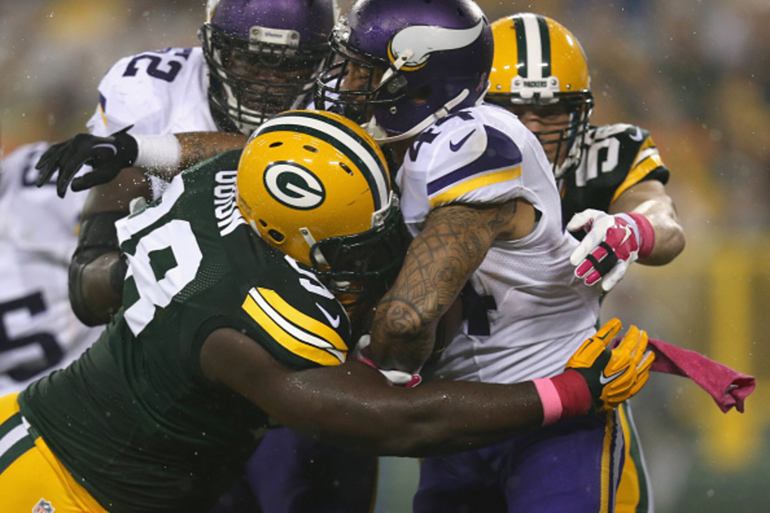 GREEN BAY, WI - OCTOBER 02:  Matt Asiata #44 of the Minnesota Vikings is tackled by Letroy Guion #98 of the Green Bay Packers at Lambeau Field on October 2, 2014 in Green Bay, Wisconsin.  (Photo by Jonathan Daniel/Getty Images)