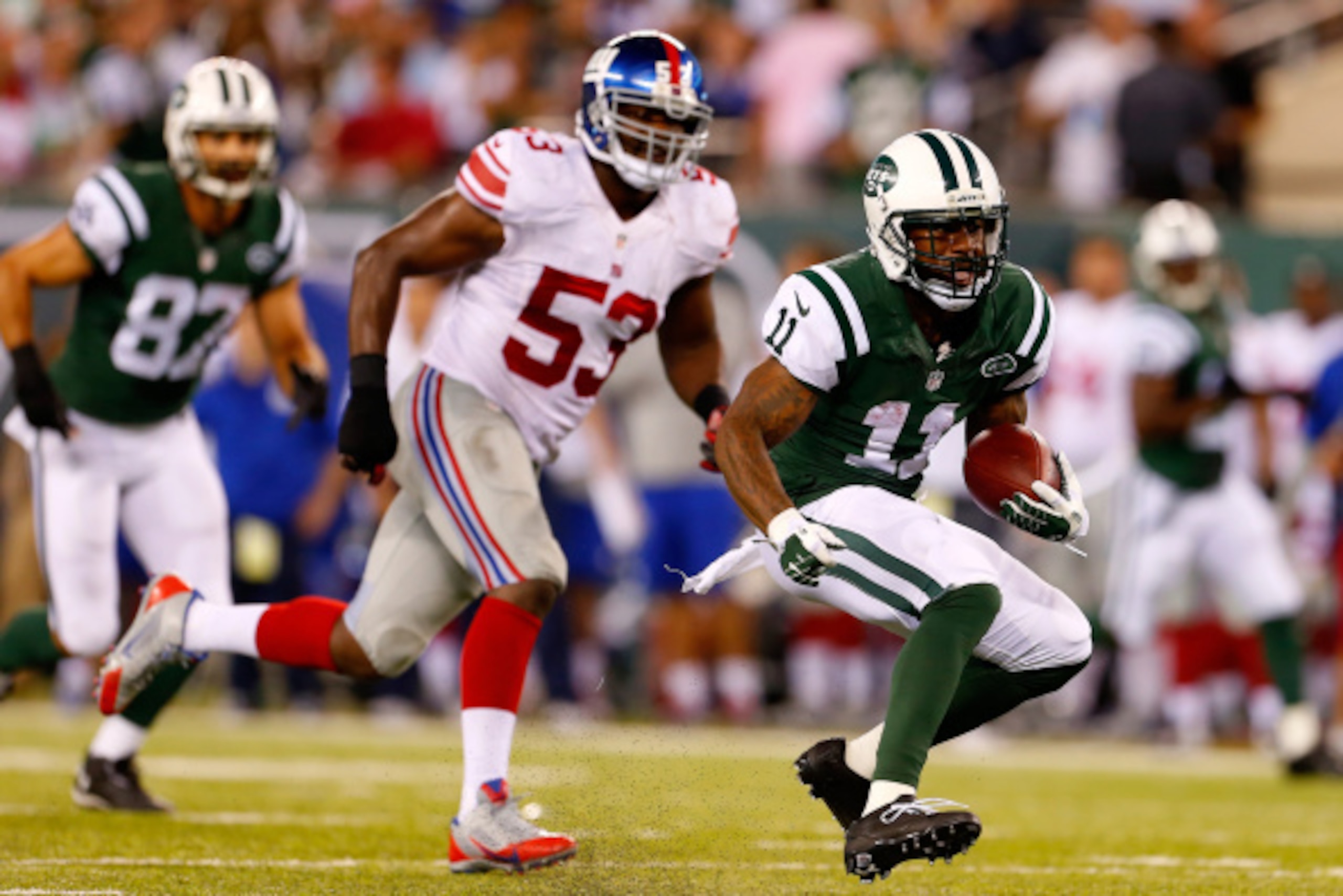 EAST RUTHERFORD, NJ - AUGUST 22:   Jeremy Kerley #11 of the New York Jets runs the ball from  Jameel McClain #53 of the New York Giants during the third quarter of a preseason game at MetLife Stadium on August 22, 2014 in East Rutherford, New Jersey.  (Ph