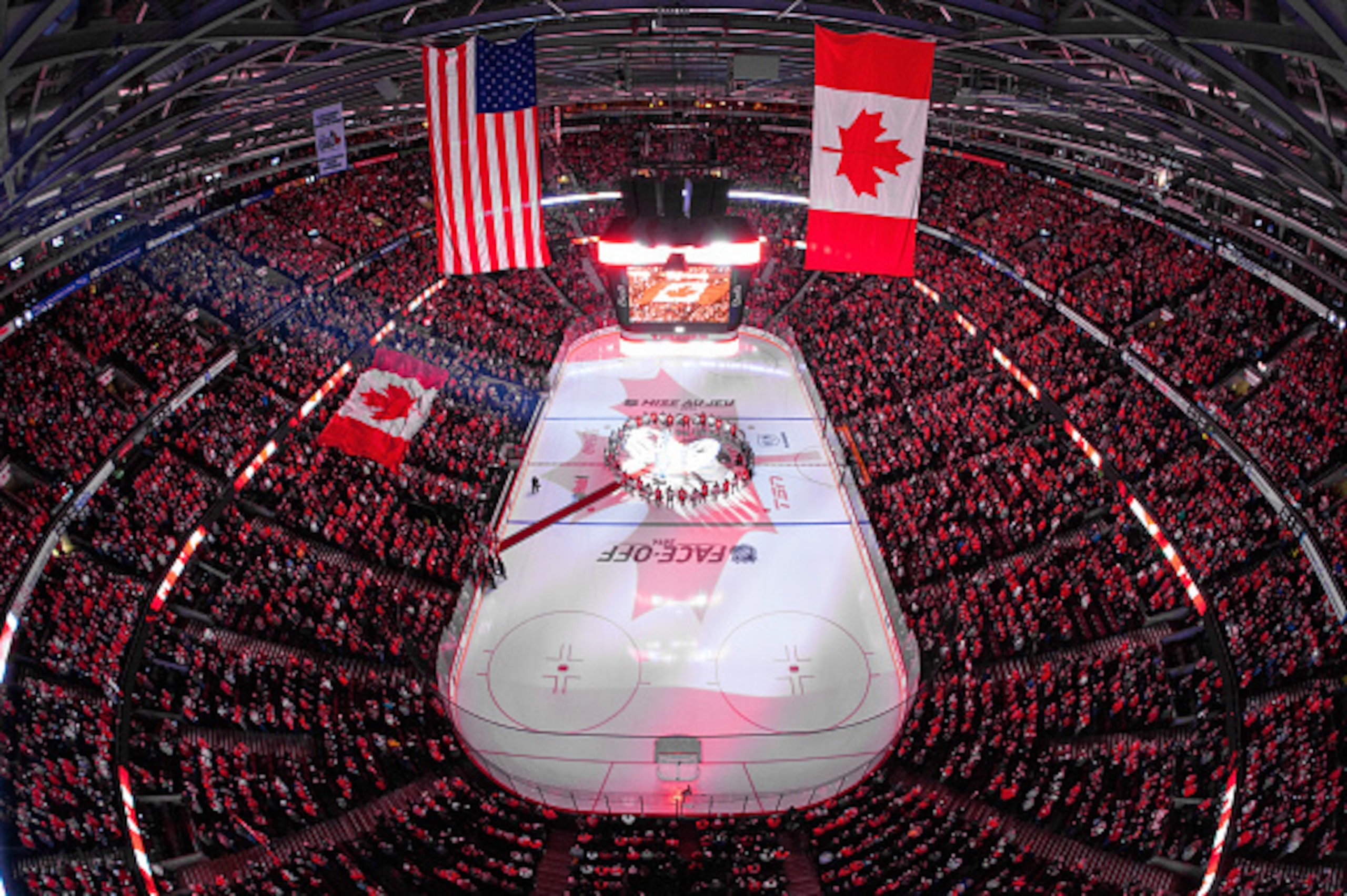 OTTAWA, ON - OCTOBER 25: In a coordinated tribute with NHL games in Montreal and Toronto to honor Canadian soldiers who lost their lives this past week, members of the Ottawa Senators and the New Jersey Devils stand together at center ice for the national OTTAWA, ON - OCTOBER 25: In a coordinated tribute with NHL games in Montreal and Toronto to honor Canadian soldiers who lost their lives this past week, members of the Ottawa Senators and the New Jersey Devils stand together at center ice for the national