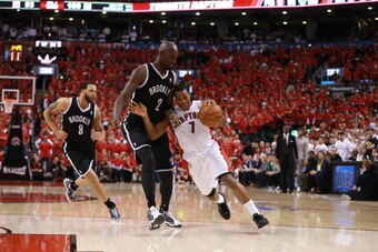 TORONTO,ON - MAY 4: Kyle Lowry #7 of the Toronto Raptors drives to the basket during Game seven of the Quarterfinal NBA Eastern Conference playoff game against Kevin Garnett #2 of the Brooklyn Nets at the Air Canada Centre on May 4, 2014 in Toronto, Ontar
