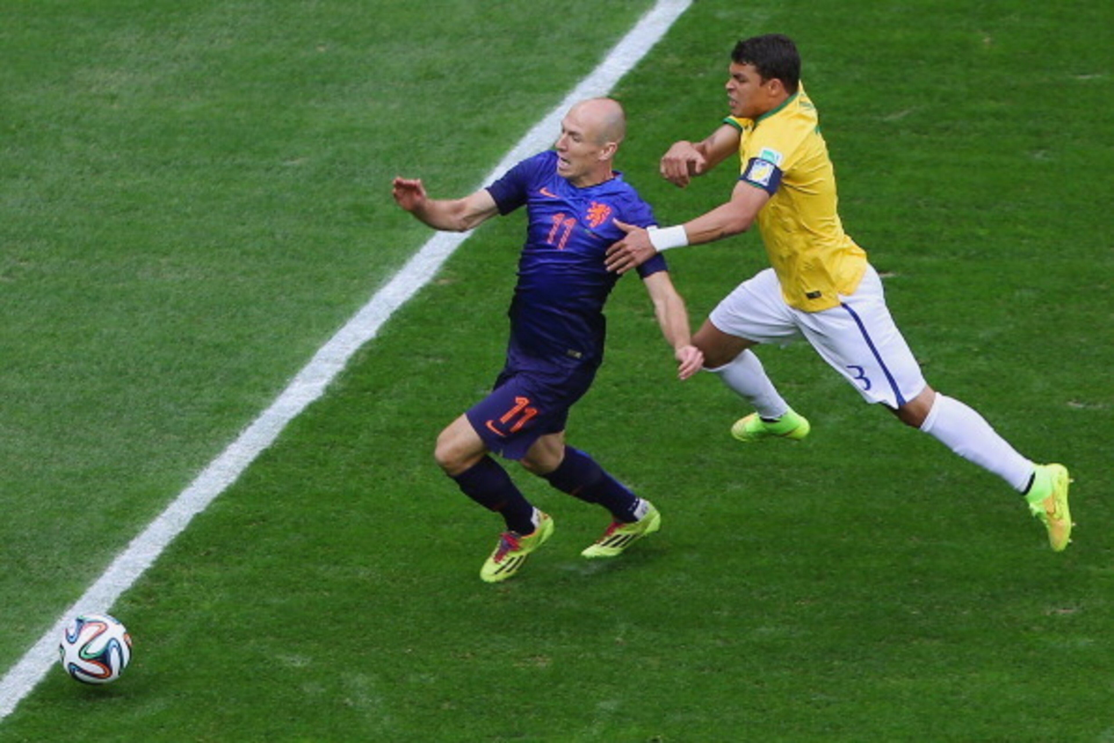 BRASILIA, BRAZIL - JULY 12:  Thiago Silva of Brazil challenges Arjen Robben of the Netherlands resulting in a penalty kick for the Netherlands and yellow card for Silva during the 2014 FIFA World Cup Brazil Third Place Playoff match between Brazil and the
