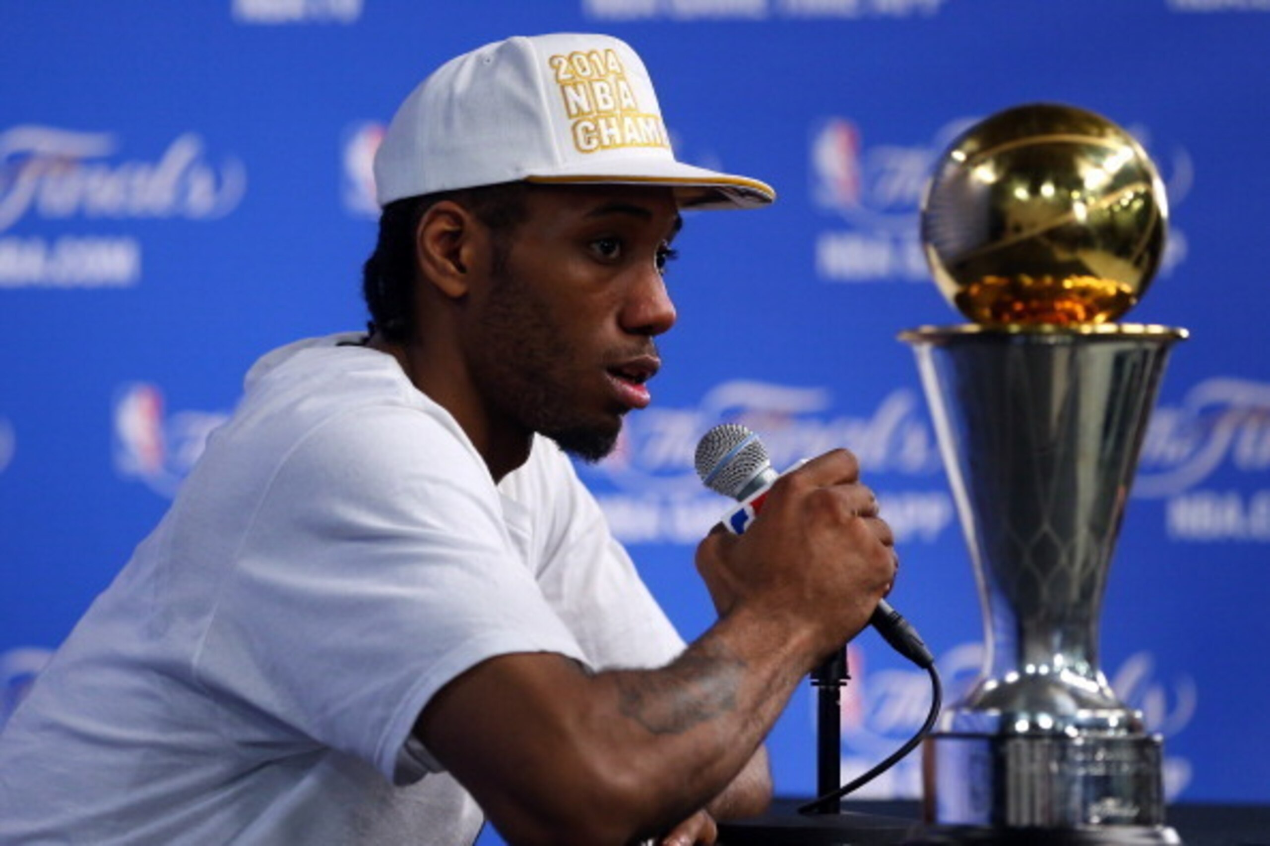 SAN ANTONIO, TX - JUNE 15: Finals MVP Kawhi Leonard #2 of the San Antonio Spurs speaks to the media after defeating the Miami Heat in Game Five of the 2014 NBA Finals 104-87 at the AT&T Center on June 15, 2014 in San Antonio, Texas. NOTE TO USER: User ex SAN ANTONIO, TX - JUNE 15: Finals MVP Kawhi Leonard #2 of the San Antonio Spurs speaks to the media after defeating the Miami Heat in Game Five of the 2014 NBA Finals 104-87 at the AT&T Center on June 15, 2014 in San Antonio, Texas. NOTE TO USER: User ex